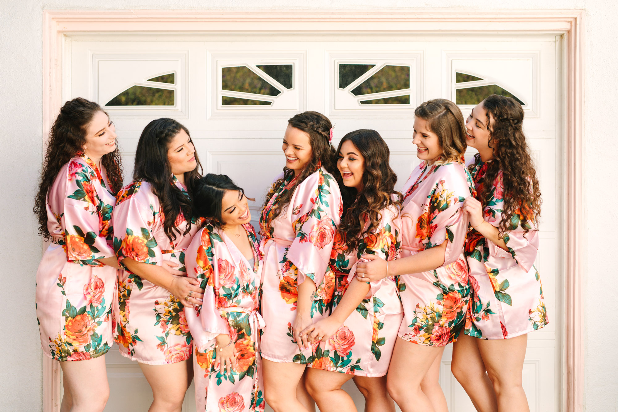 Bridesmaids in floral robes by Mary Costa Photography