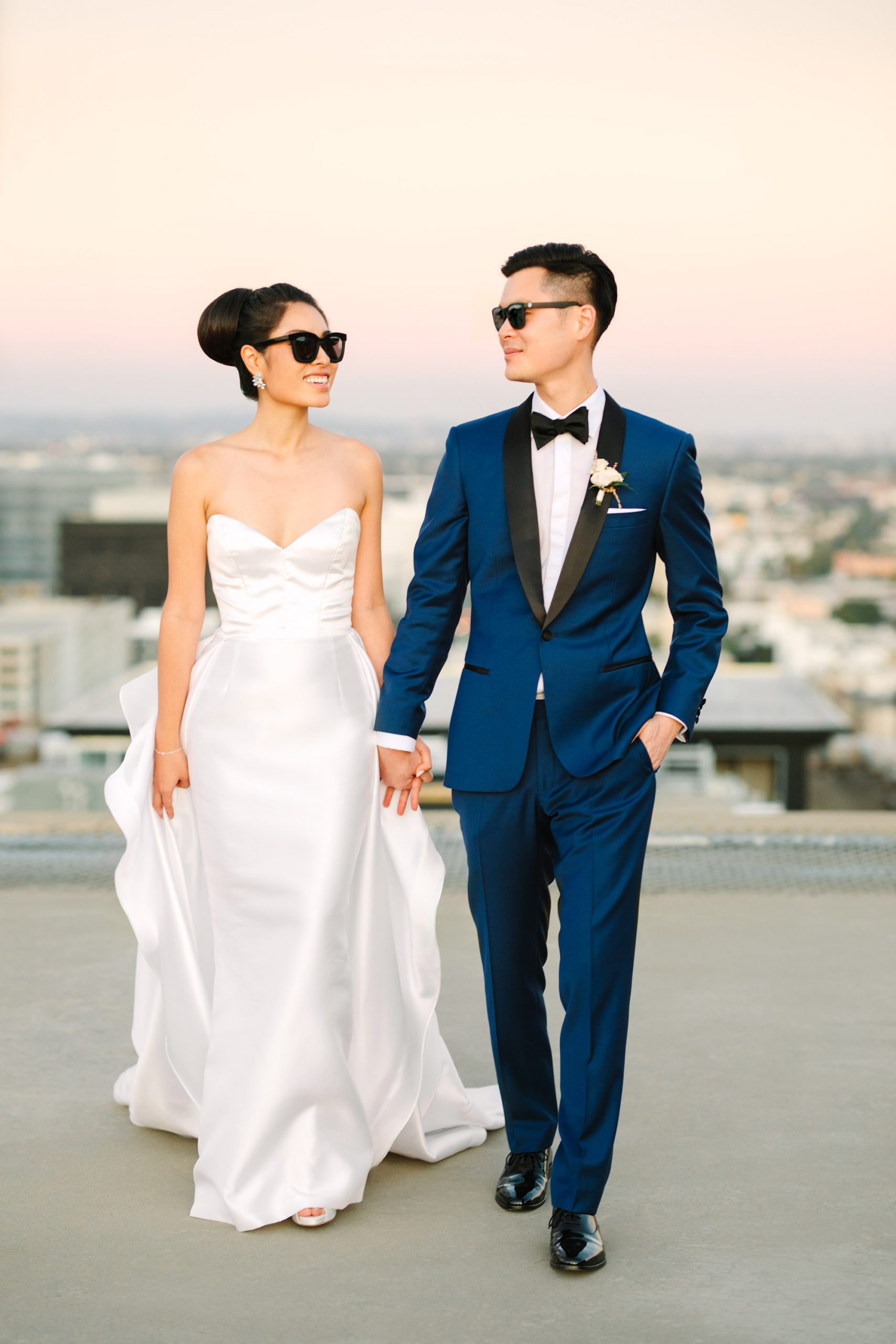 Bride and groom walking in sunglasses on Los Angeles www.marycostaweddings.com
