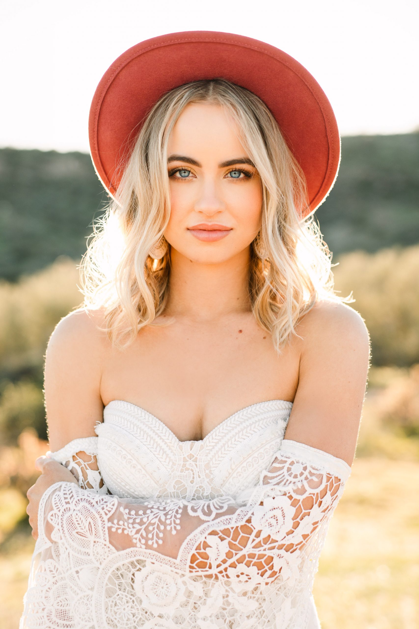 Bride in bold hat by Mary Costa Photography