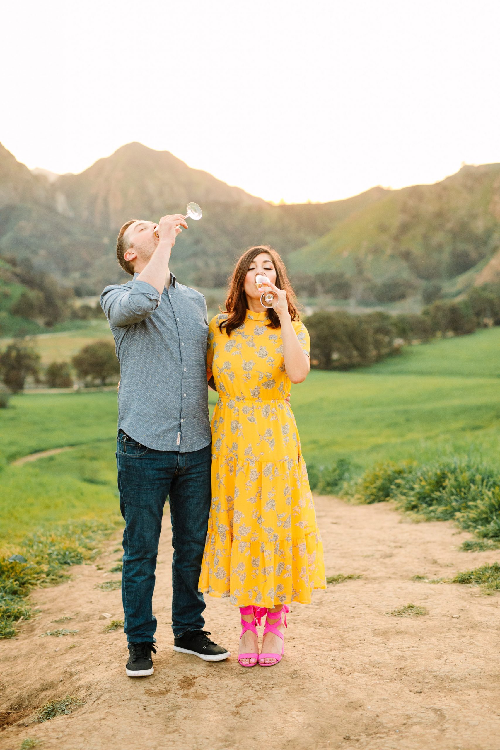 Couple drinking champagne during engagement session by Mary Costa Photography