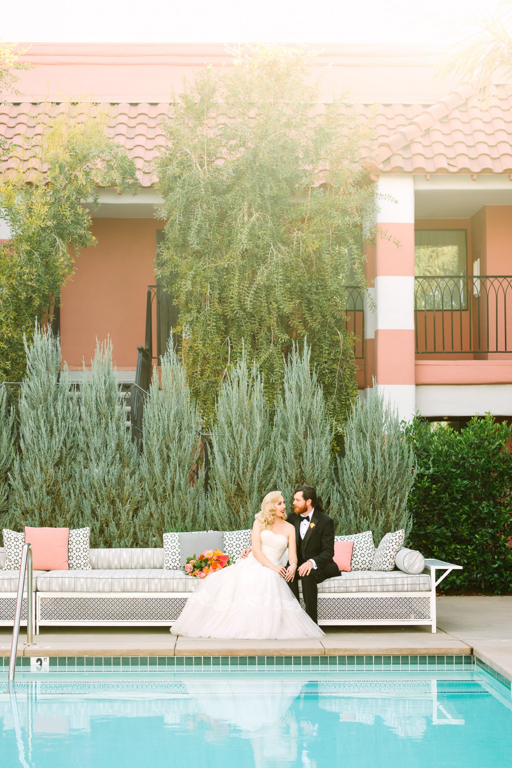 Wedding portrait of couple by pool