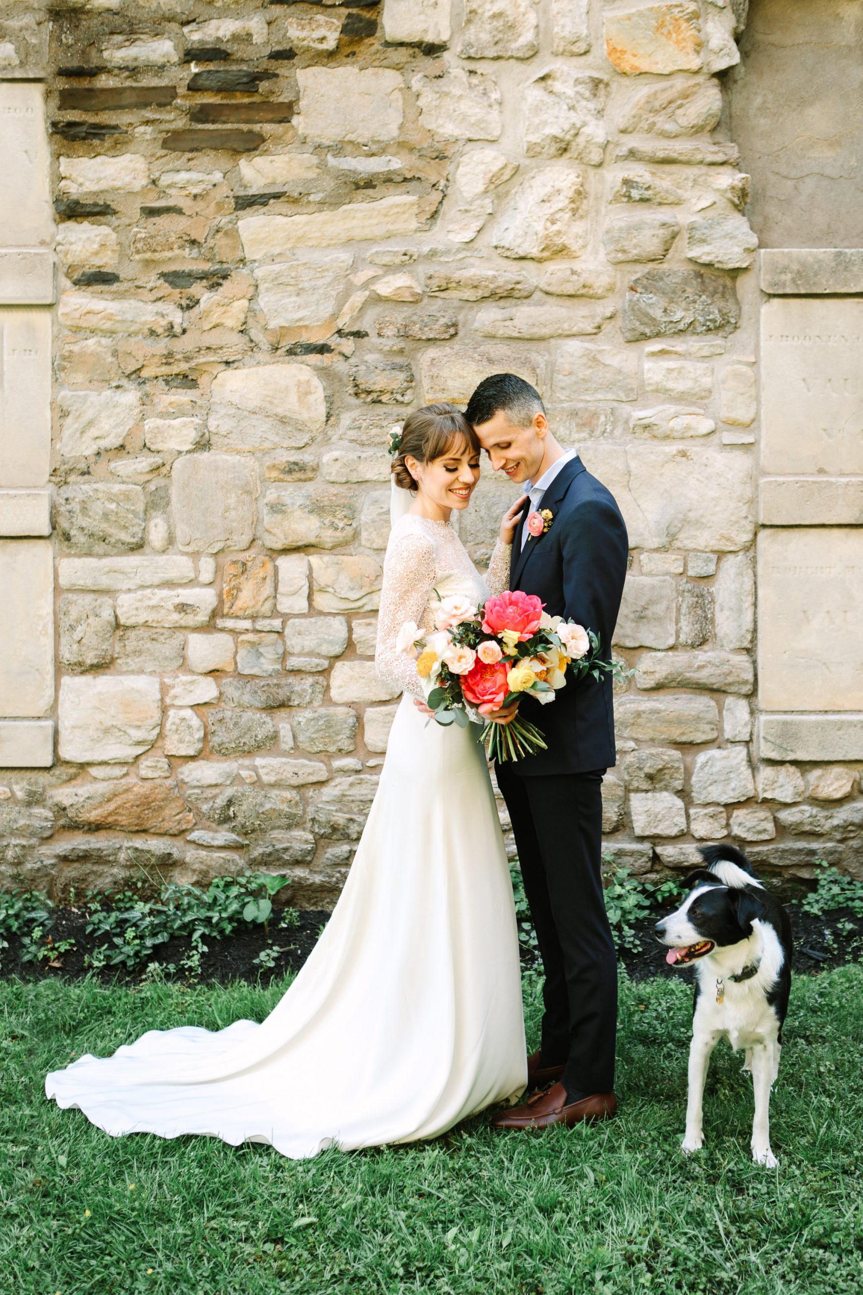 Bride and groom with their dog by Mary Costa Photography