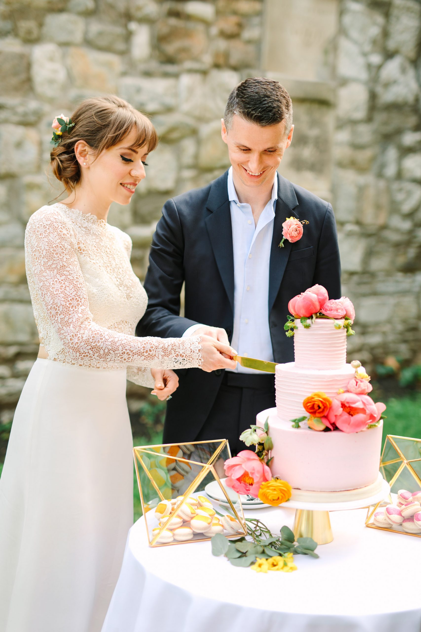 Bride and groom cutting wedding cake by Mary Costa Photography