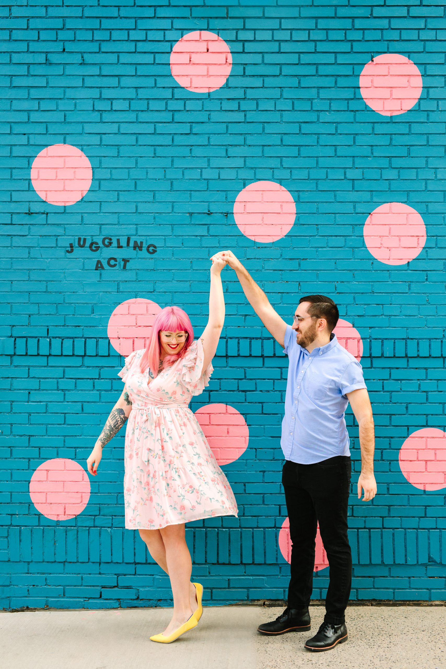 Colorful couple twirling by Mary Costa Photography