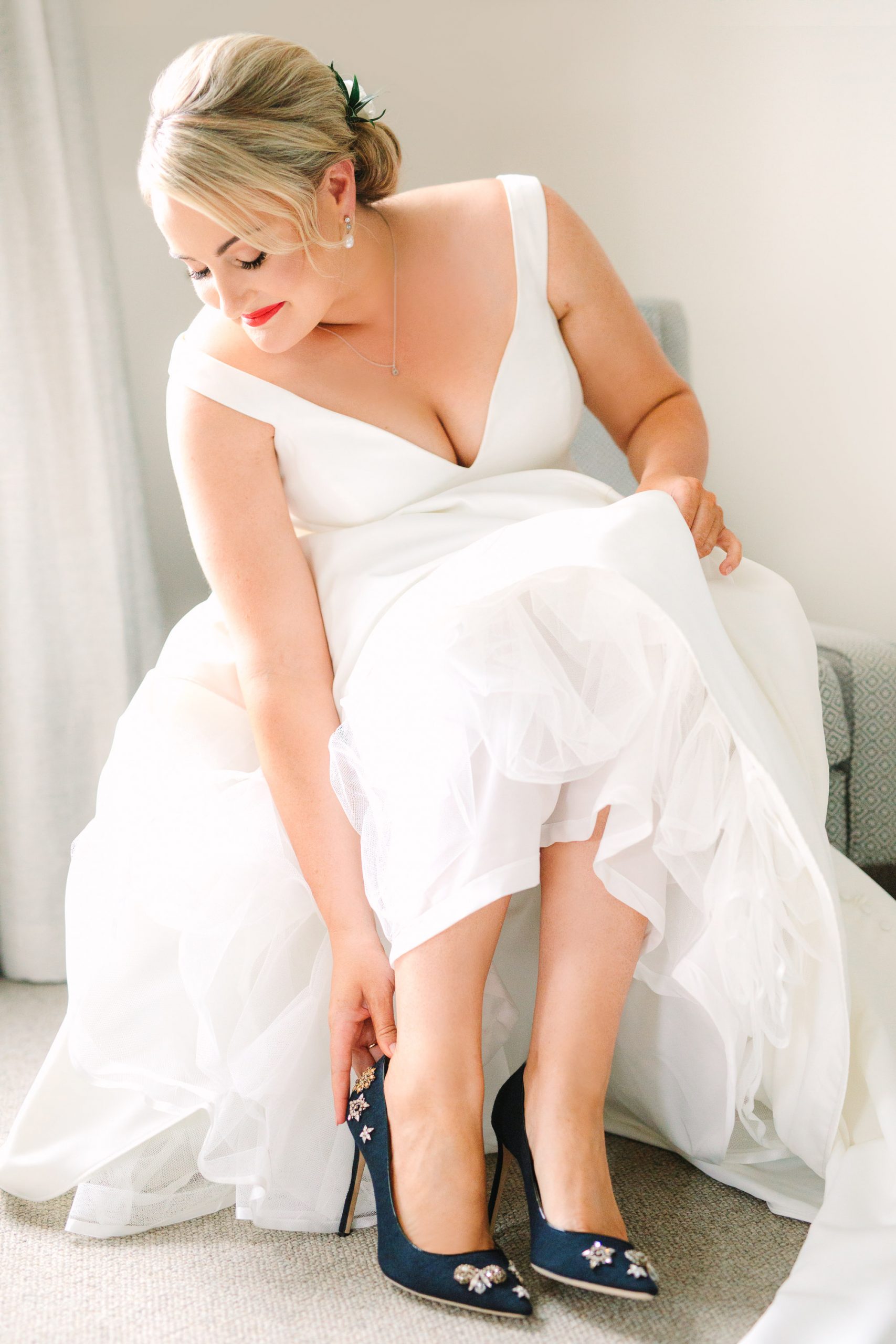 Bride putting on shoes Indian Fusion wedding at Fig House Los Angeles by Mary Costa Photography