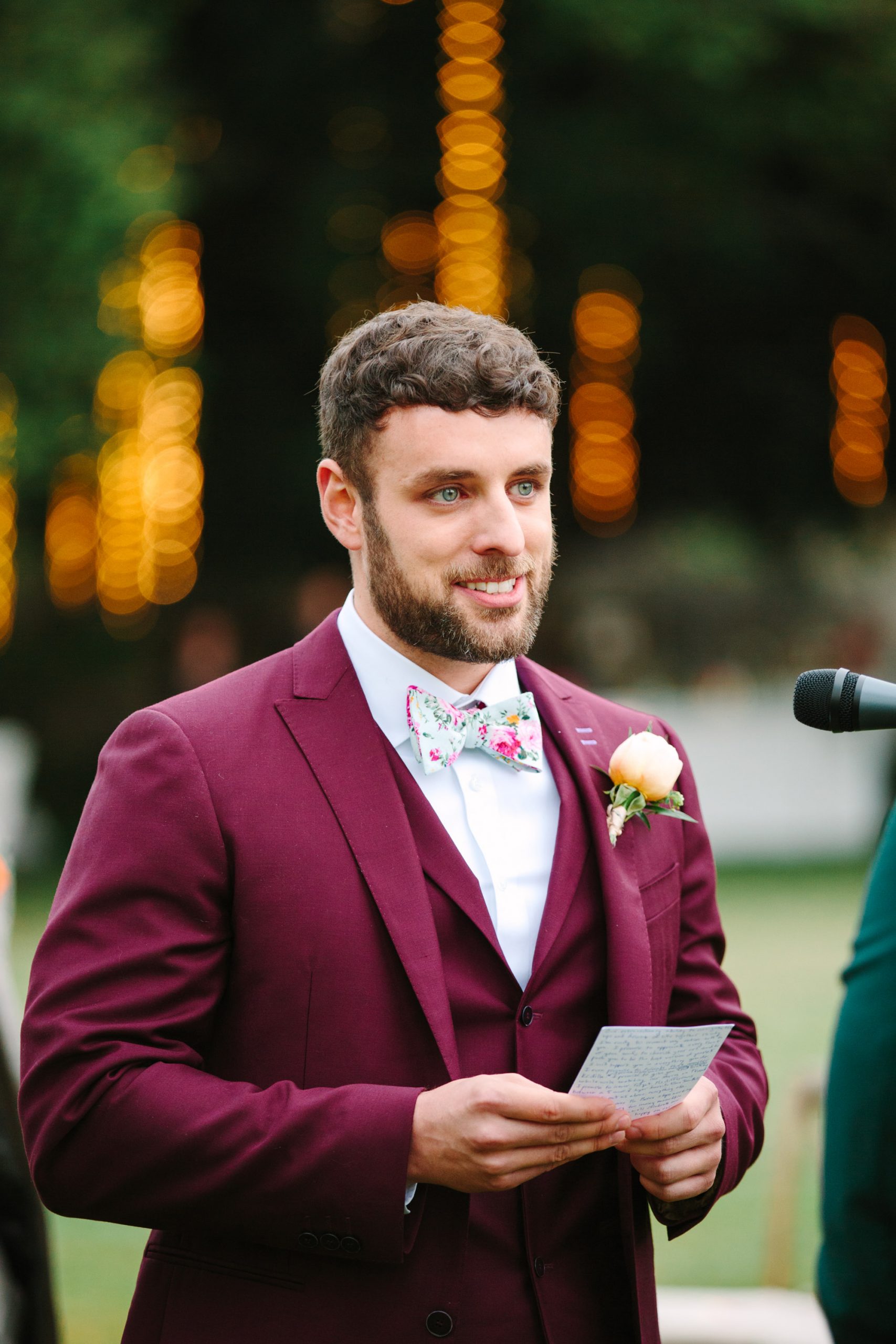 Groom in wine red tux by Mary Costa Photography