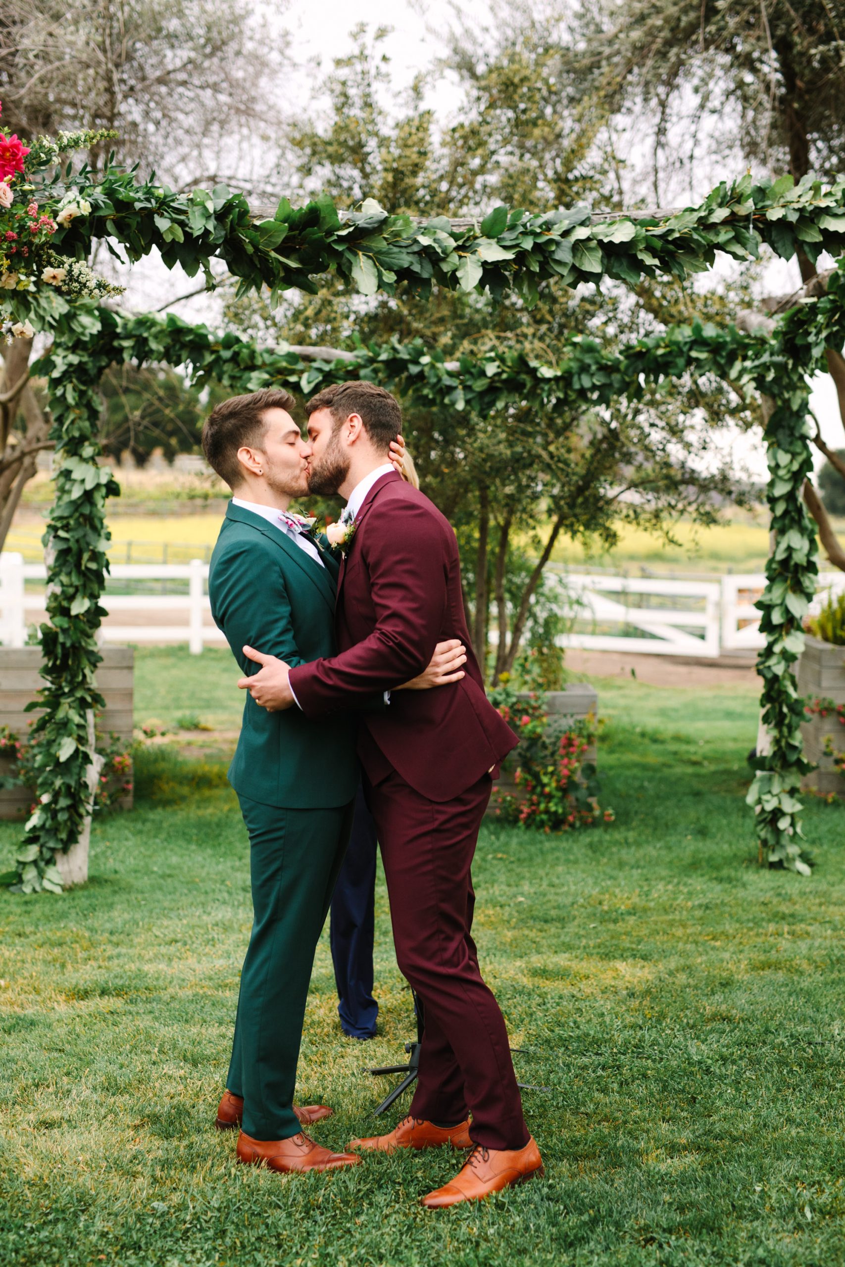 Adam and KC kissing during wedding ceremony by Mary Costa Photography