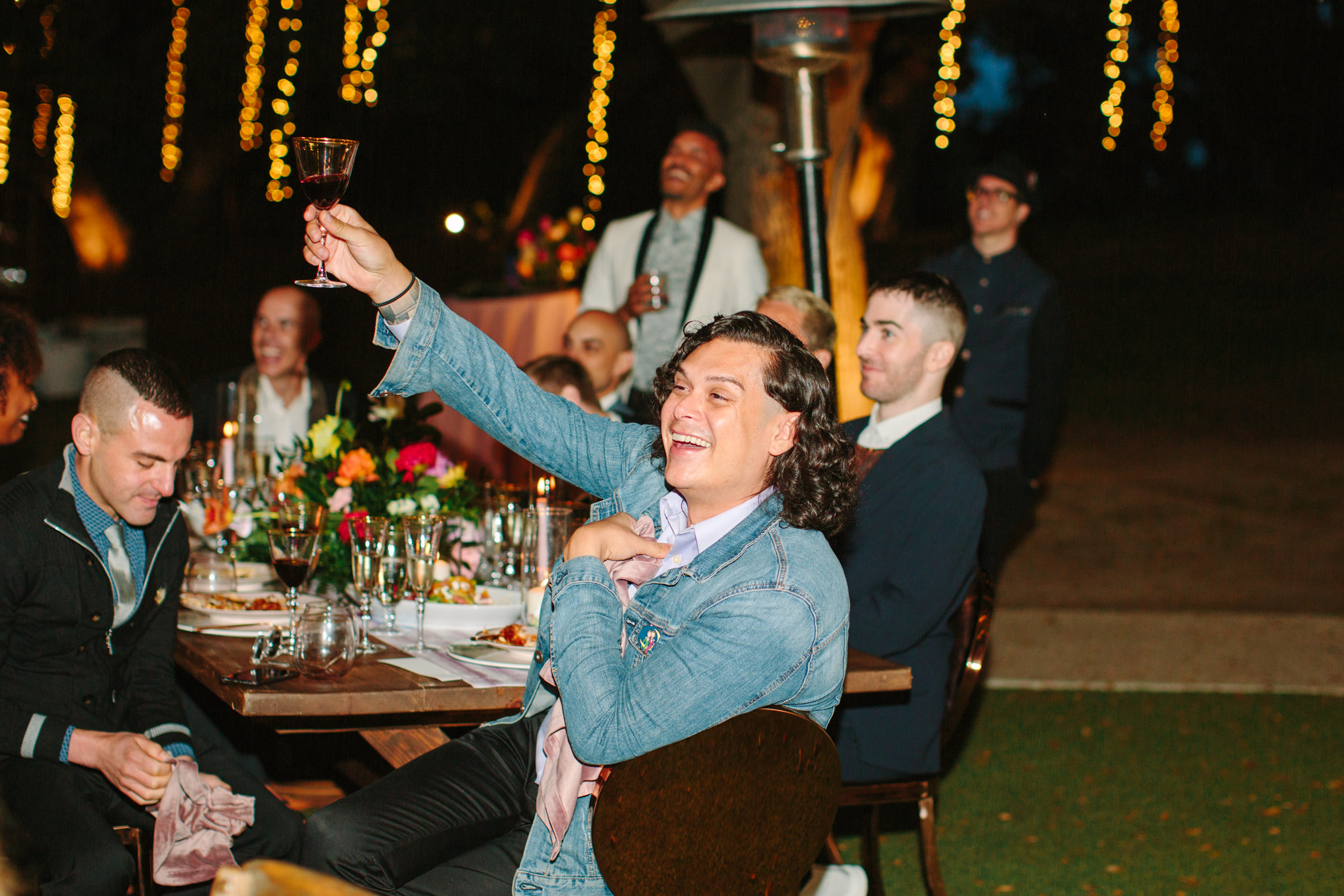 Wedding guests toasting by Mary Costa Photography