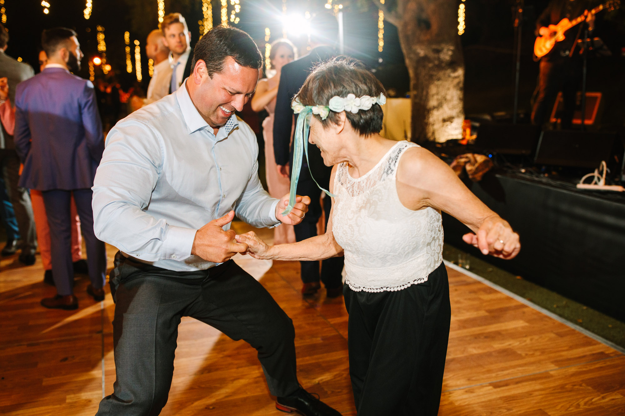 Wedding guests dancing by Mary Costa Photography