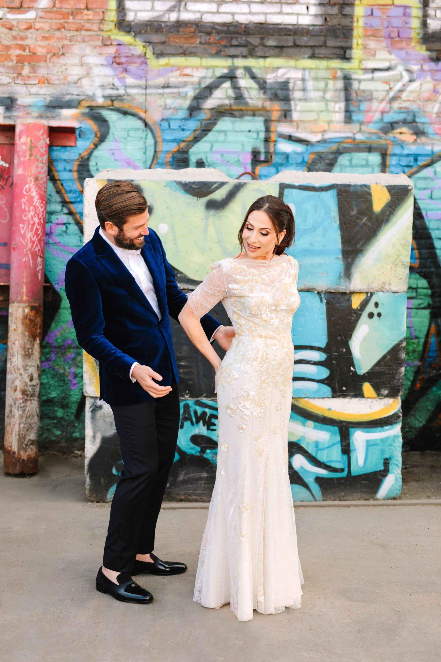 Bride and groom first look with graffiti backdrop in LA www.marycostaweddings.com