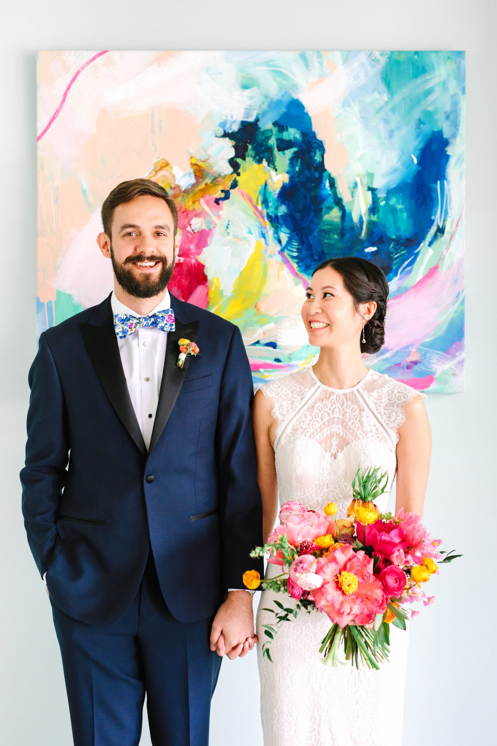 Bride and groom with colorful painting - www.marycostaweddings.com