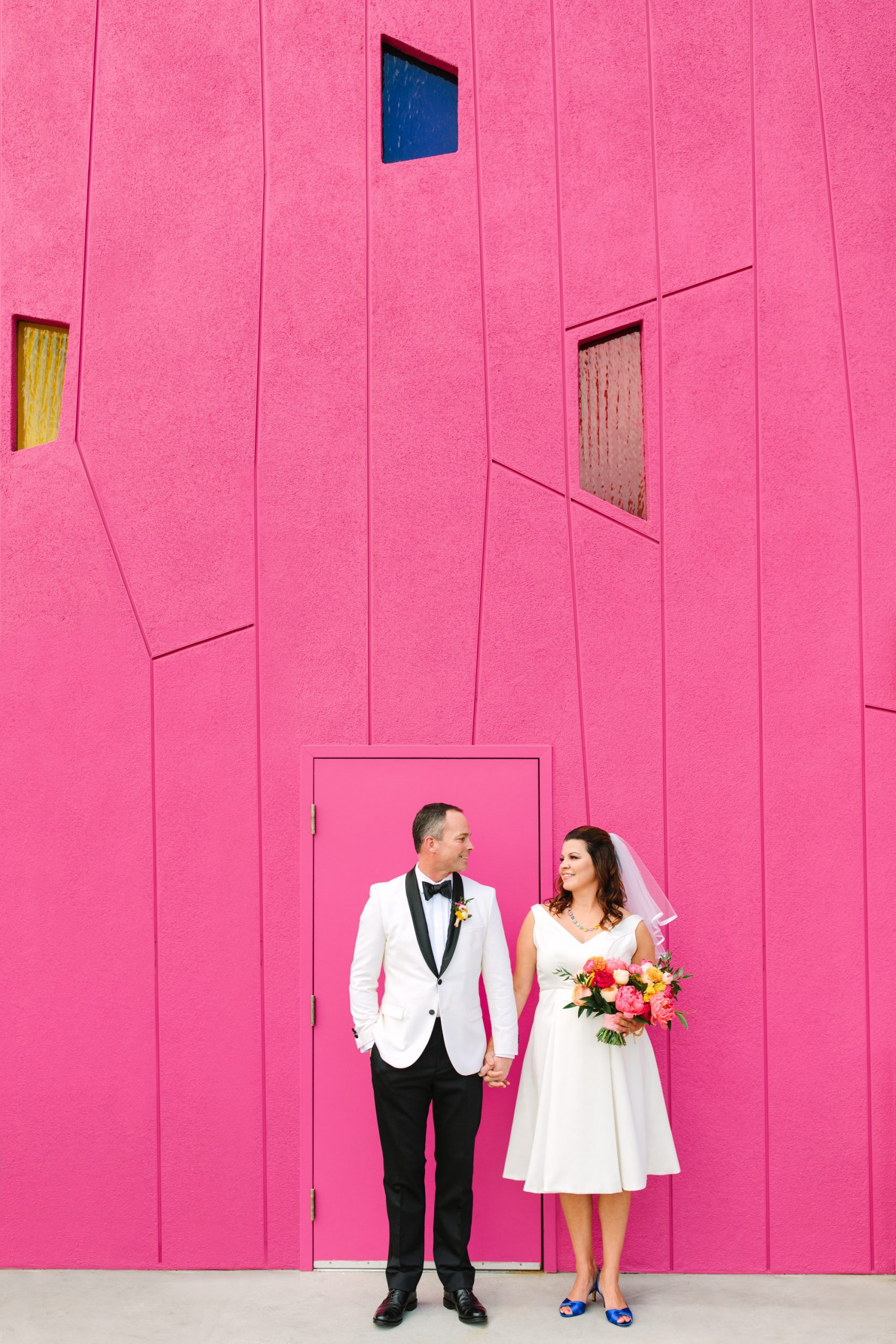 Bride and groom in front of pink wall at Saguaro Palm Springs www.marycostaweddings.com
