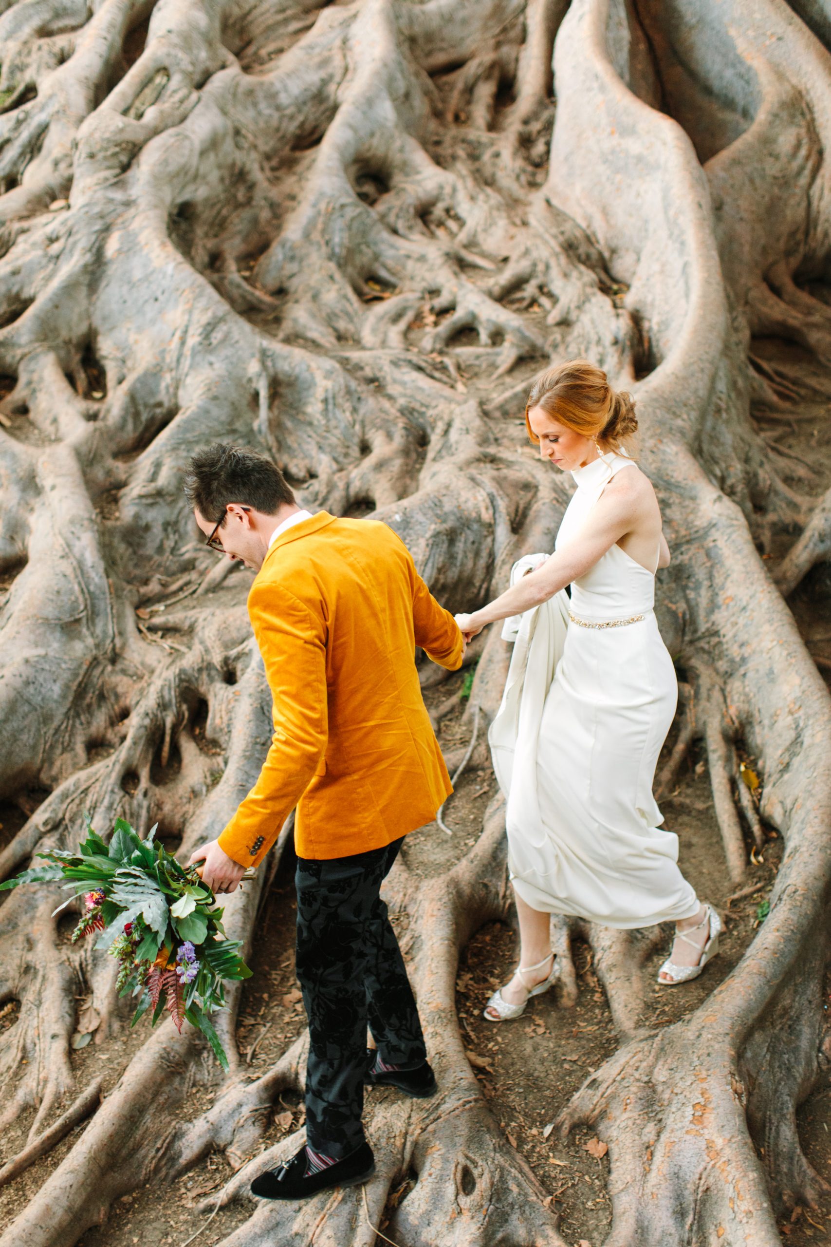 Couple walking on fig tree roots - www.marycostaweddings.com
