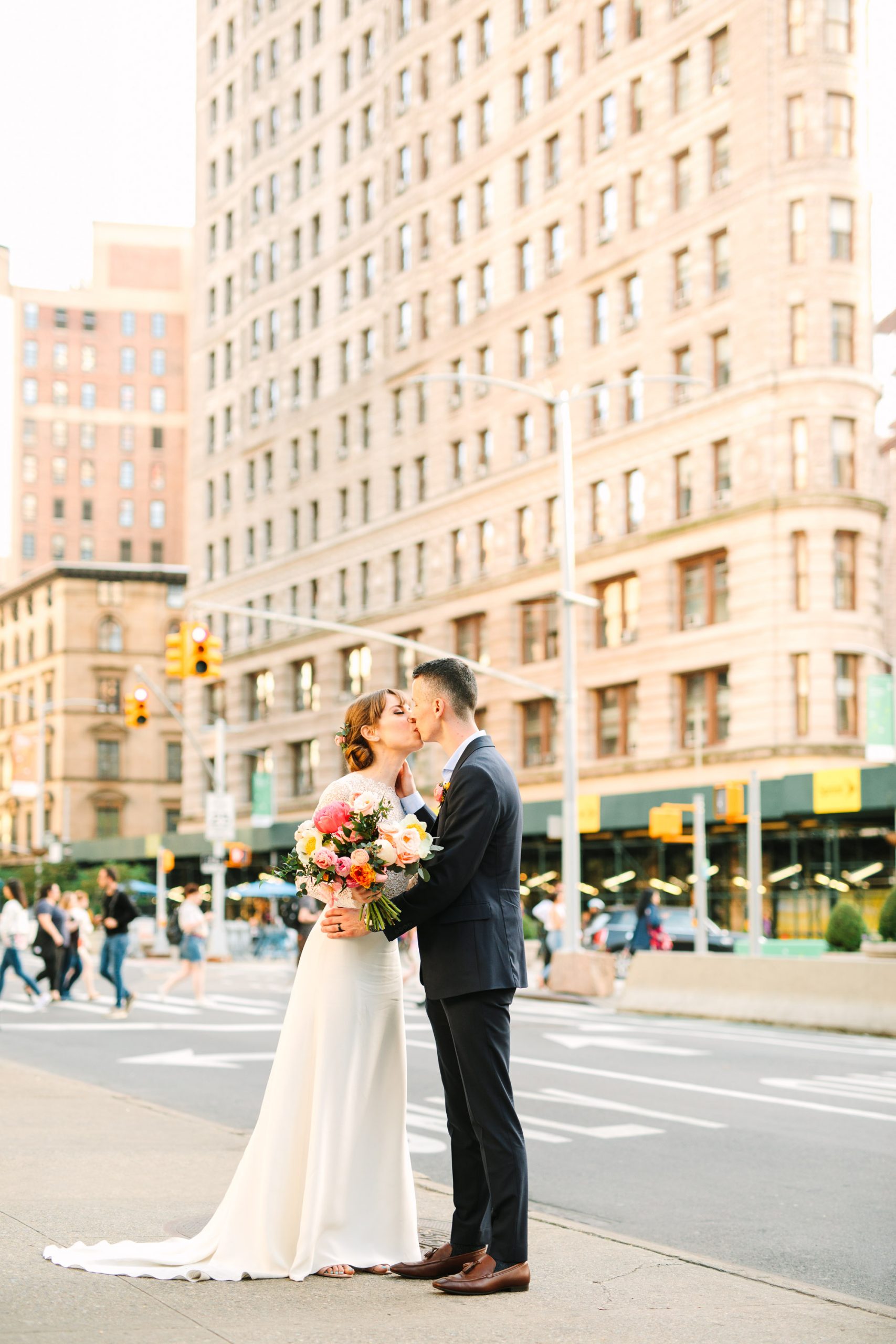 Bride and groom kissing with Flatiron Building