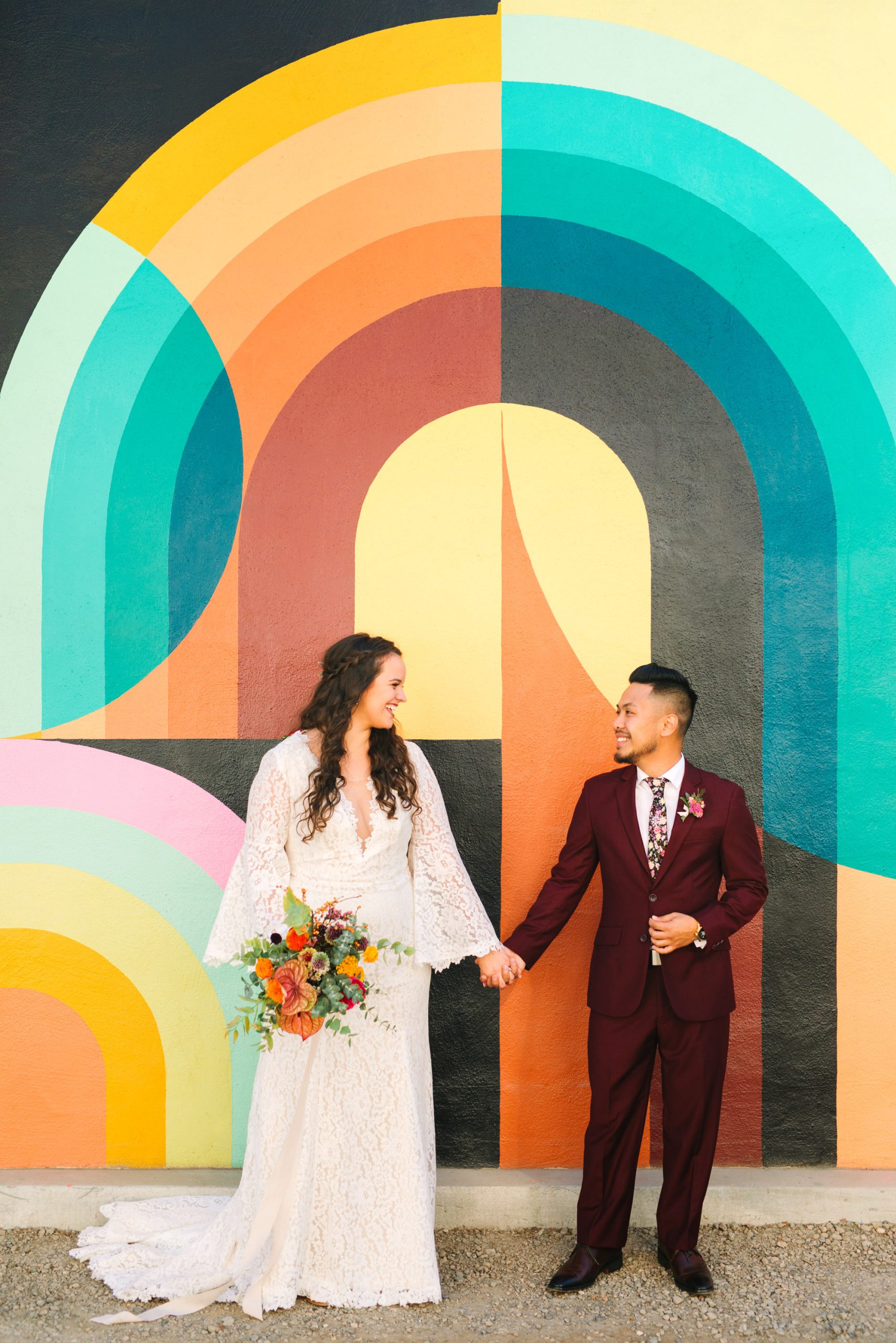Bride and groom in front of colorful Jessie and Katey mural in Sacramento - www.marycostaweddings.com