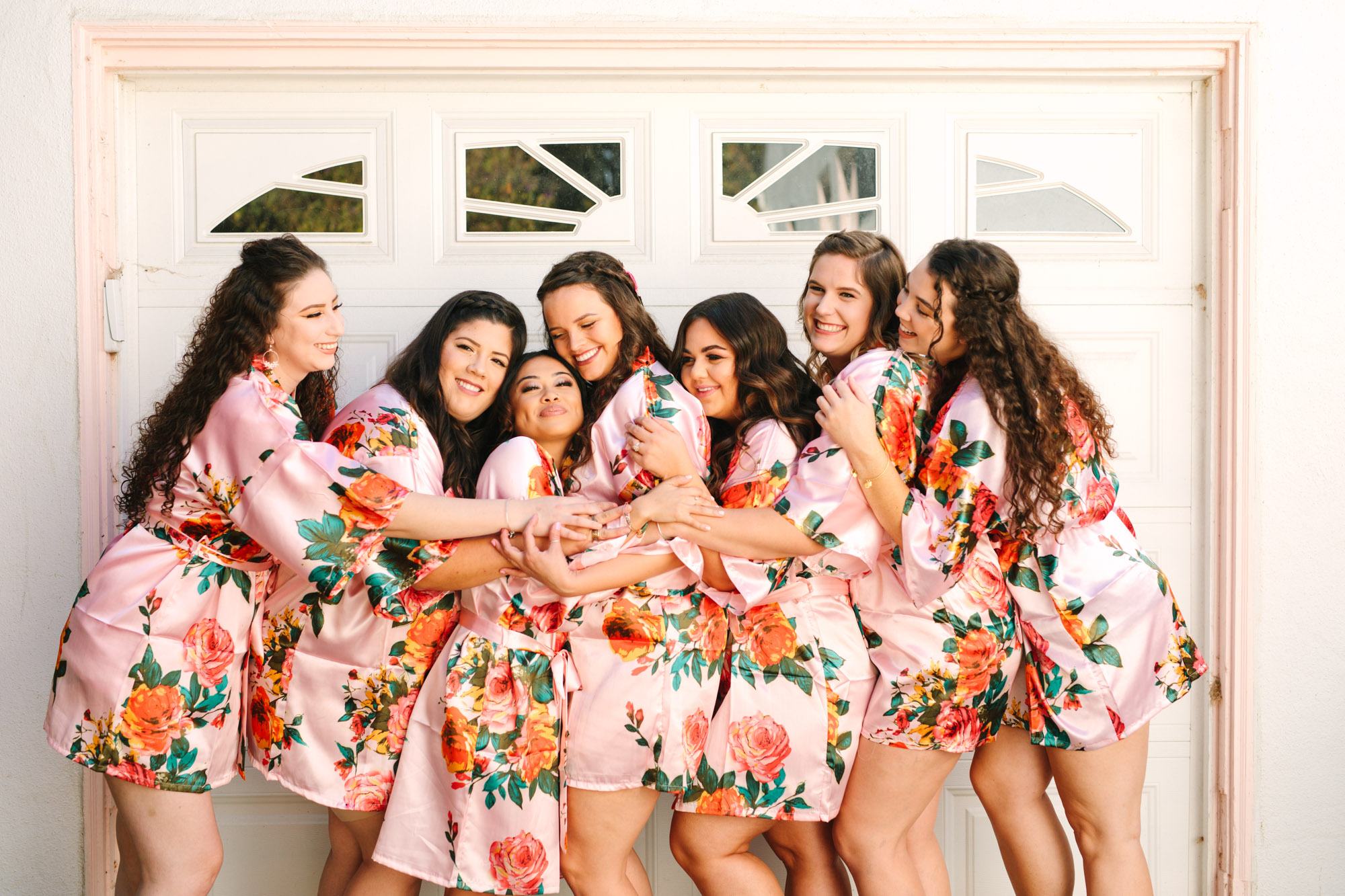 Bridal party in colorful pink floral robes - www.marycostaweddings.com