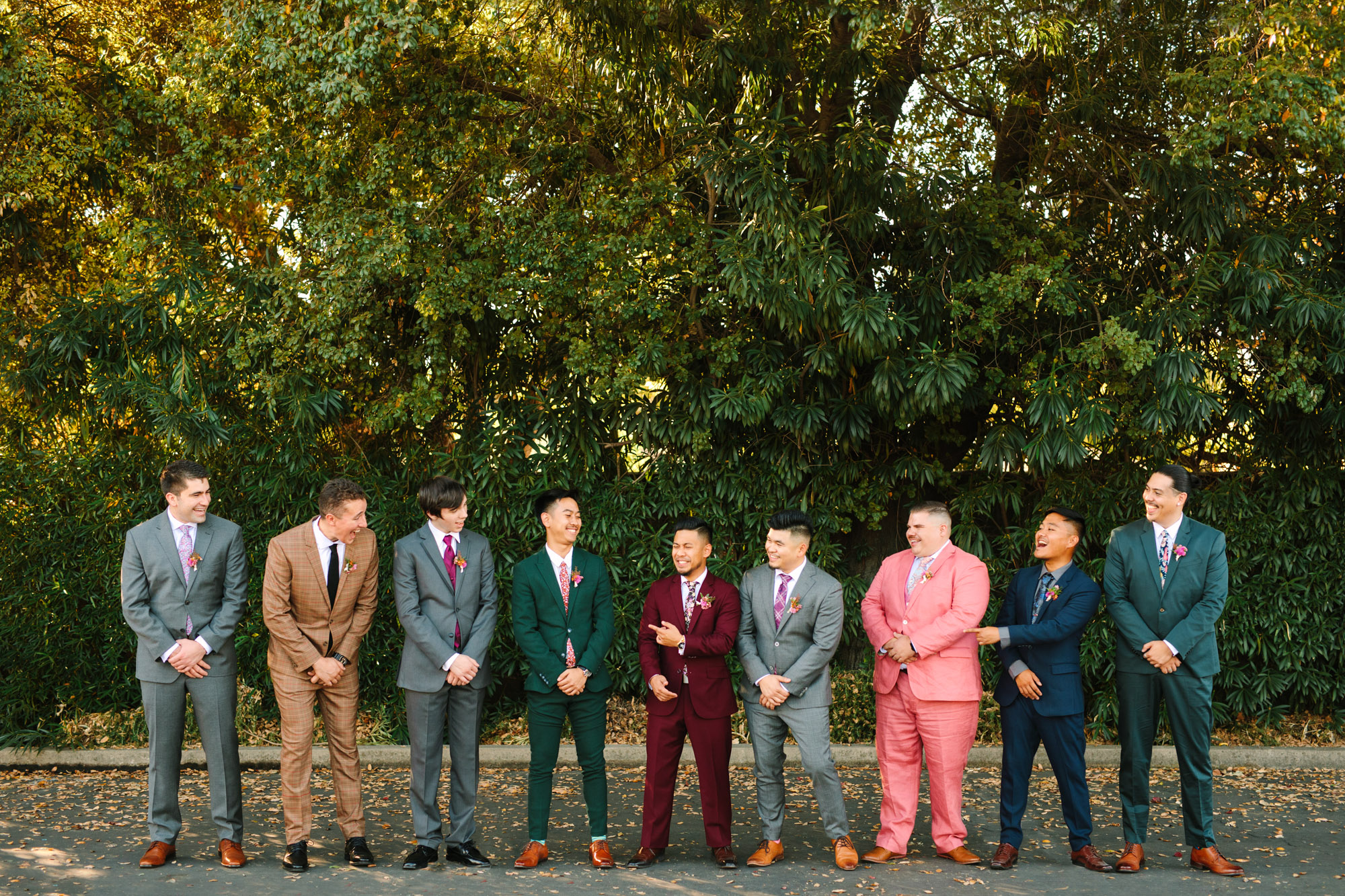 Groom and groomsmen in colorful assorted suits at BLOC Venue Roseville - www.marycostaweddings.com
