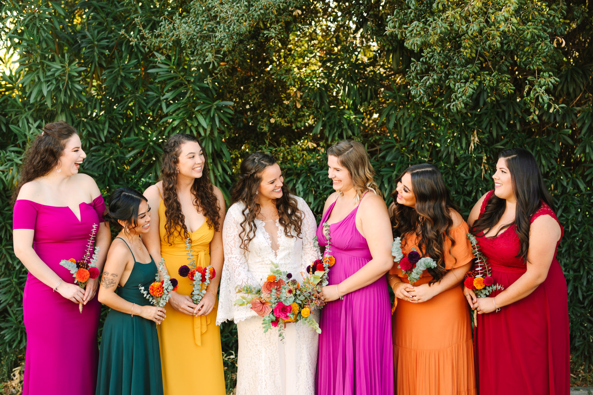 Bride and bridesmaids in colorful assorted dresses - www.marycostaweddings.com
