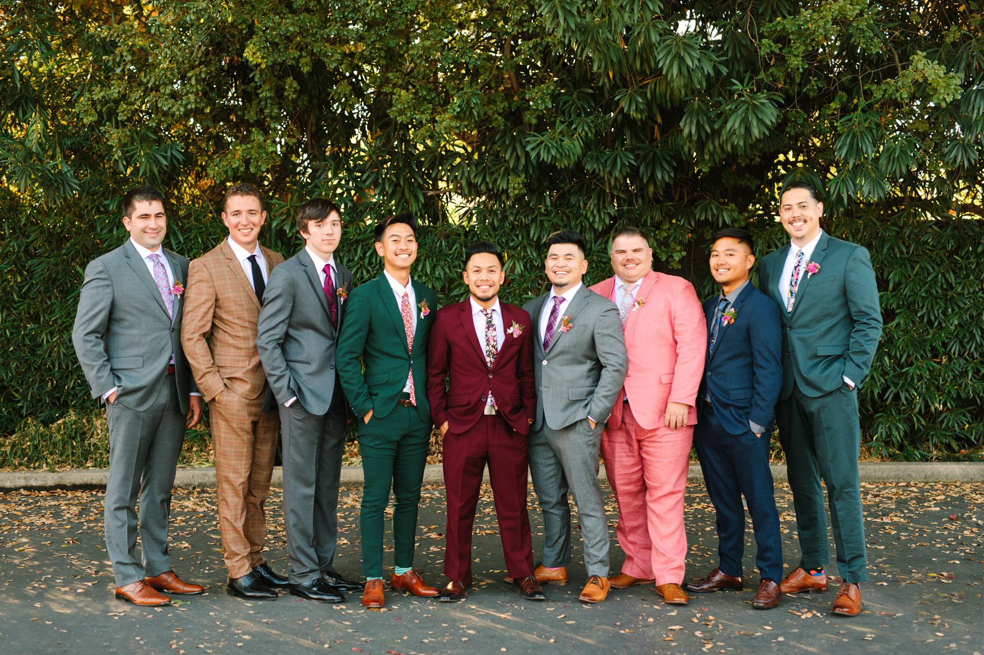 Groom and groomsmen in colorful assorted suits at BLOC Venue Roseville - www.marycostaweddings.com
