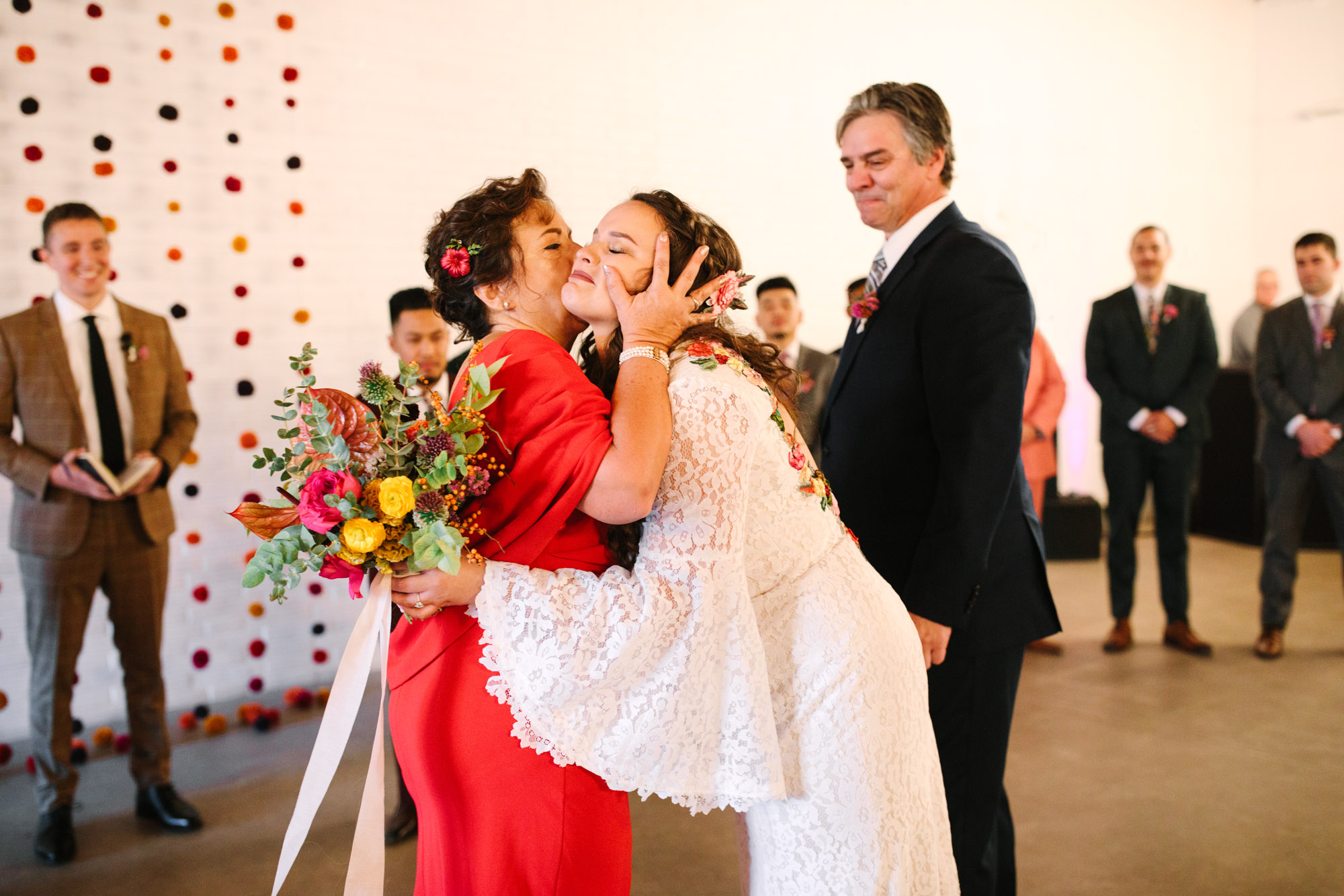 Mom kissing bride at wedding ceremony - www.marycostaweddings.com