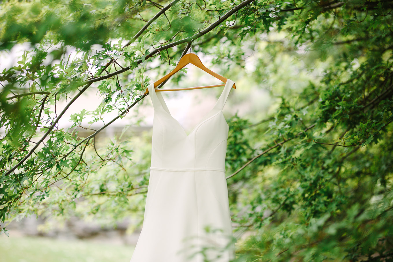 Bride's dress hanging among the trees. Millbrook Resort Queenstown New Zealand wedding by Mary Costa Photography | www.marycostaweddings.com
