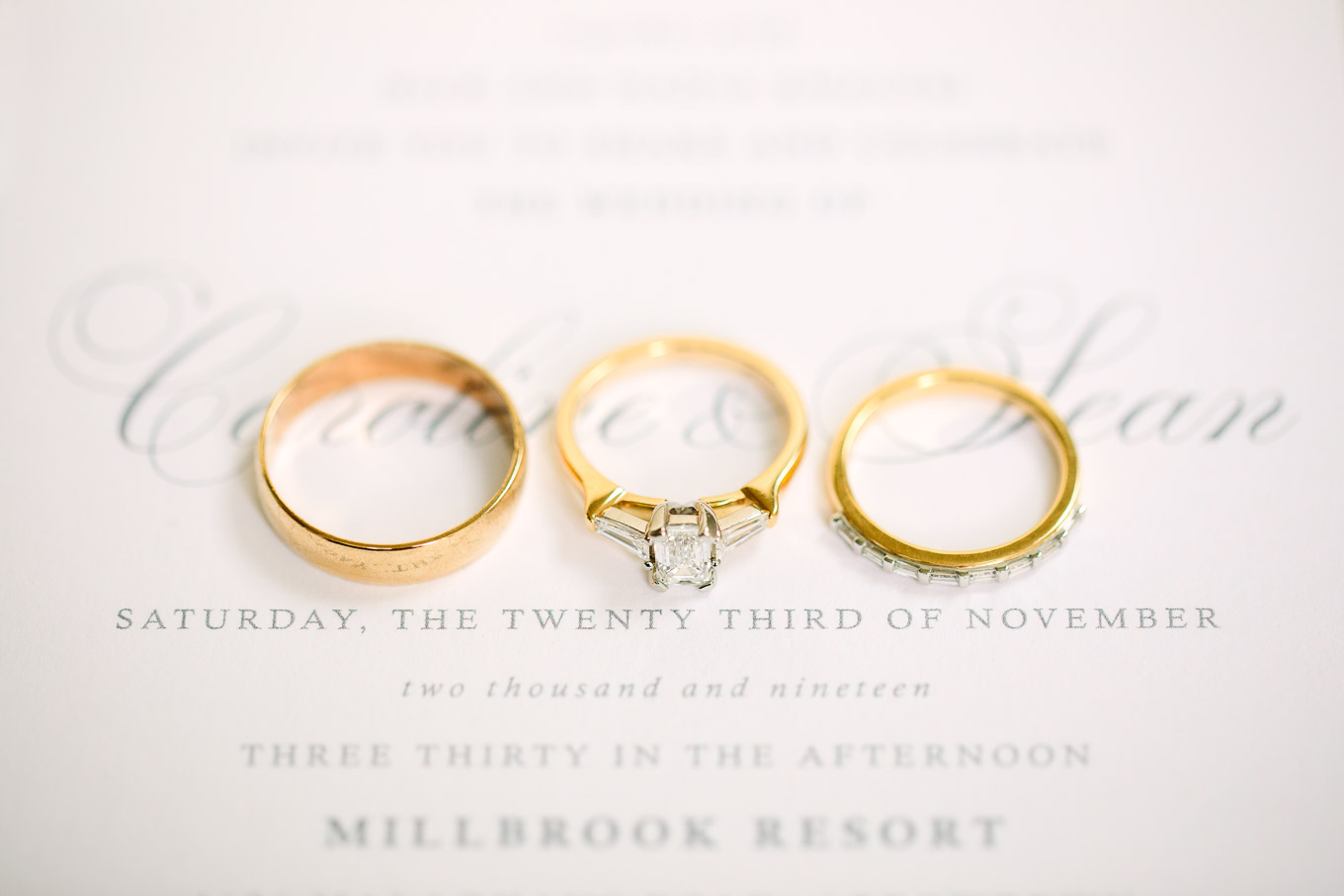 Gold and diamond wedding rings on wedding invitation. Millbrook Resort Queenstown New Zealand wedding by Mary Costa Photography | www.marycostaweddings.com
