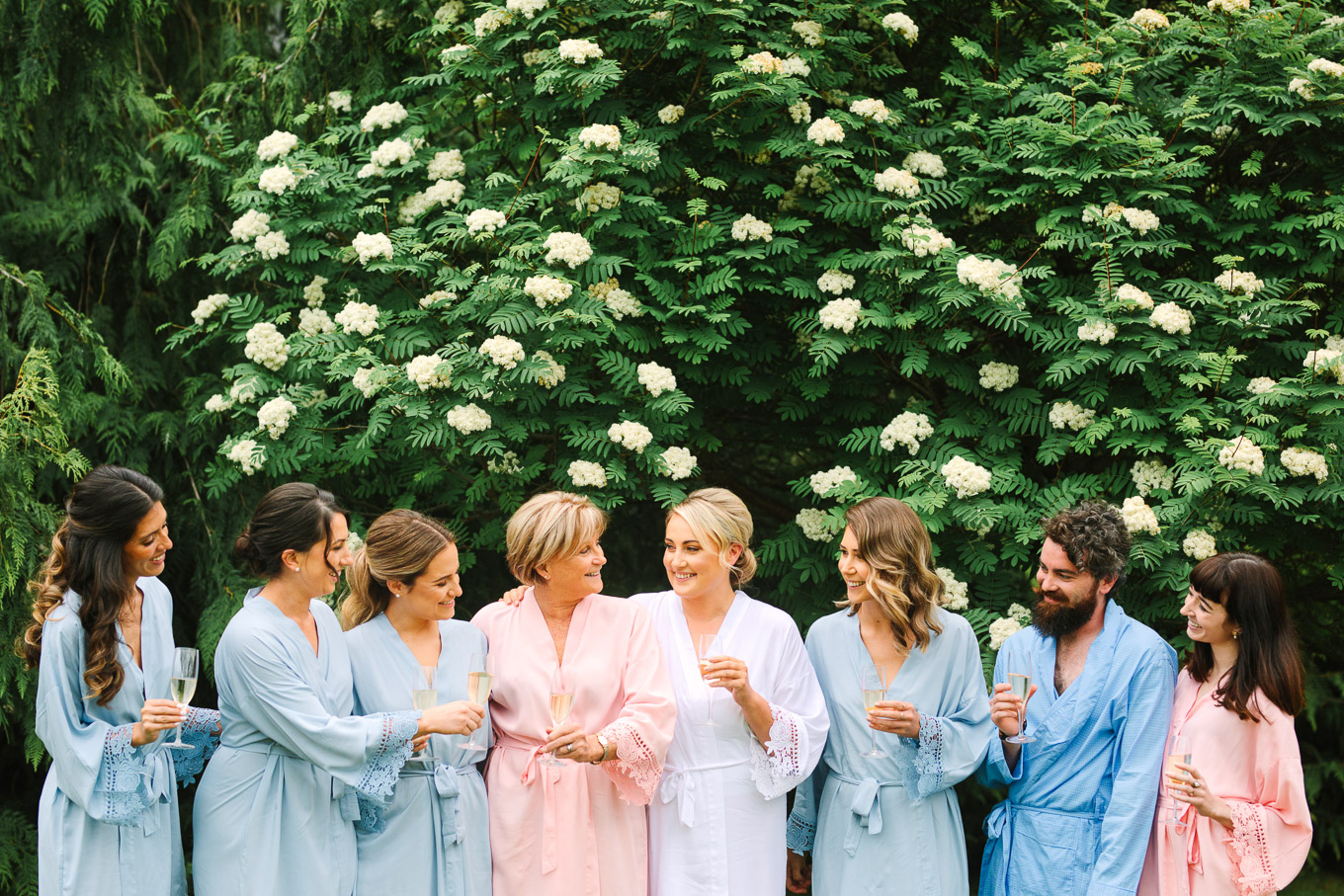 Bride, mom, and wedding party in robes with champagne. Millbrook Resort Queenstown New Zealand wedding by Mary Costa Photography | www.marycostaweddings.com