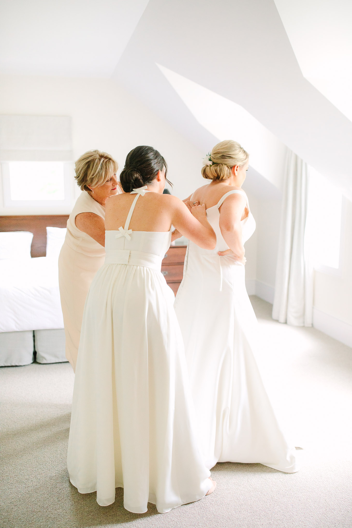 Bride getting dressed in suite. Millbrook Resort Queenstown New Zealand wedding by Mary Costa Photography | www.marycostaweddings.com