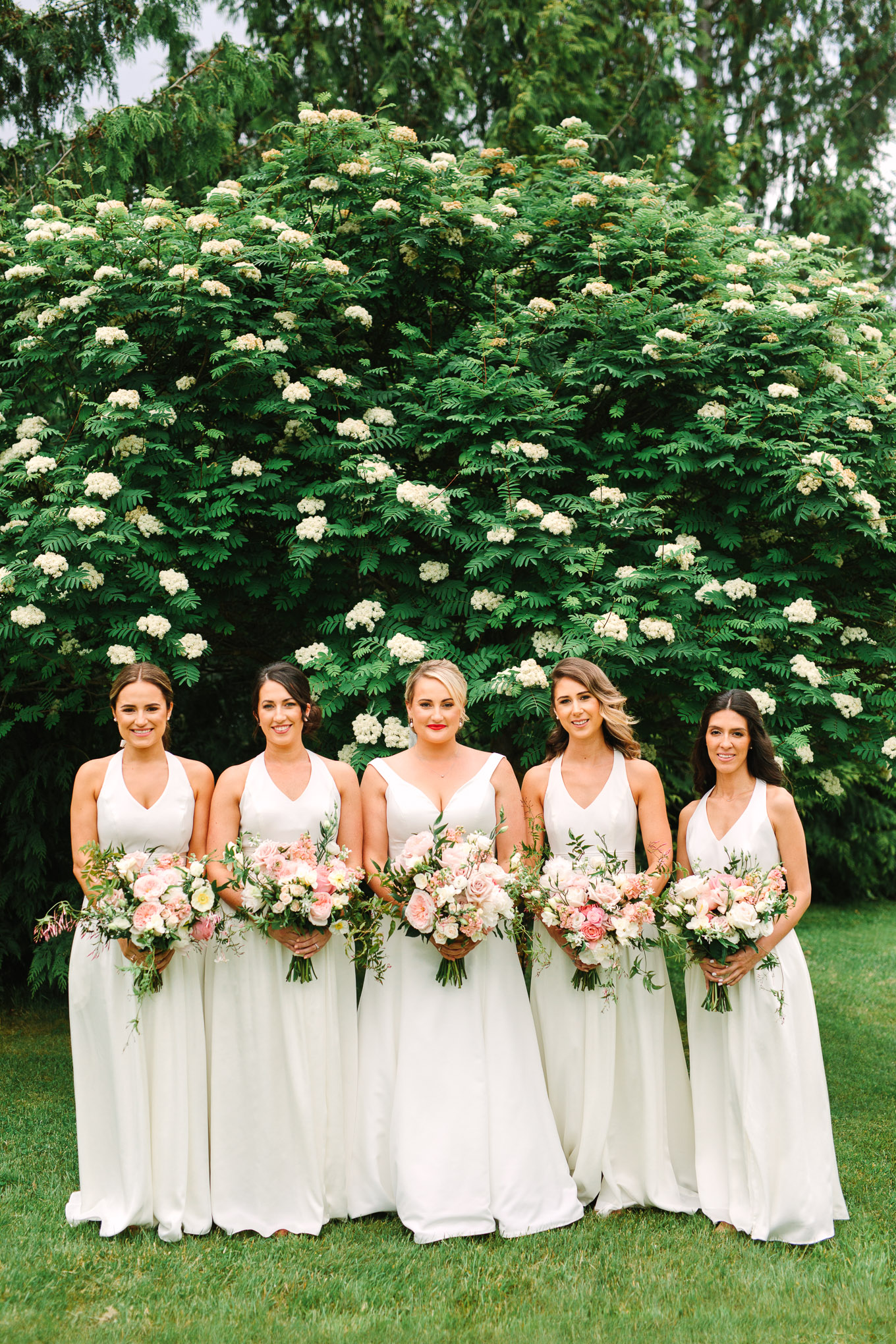 Bridal party in all white with neutral color palette bouquets. Beautiful light pink and neutral bridal bouquet. Millbrook Resort Queenstown New Zealand wedding by Mary Costa Photography | www.marycostaweddings.com
