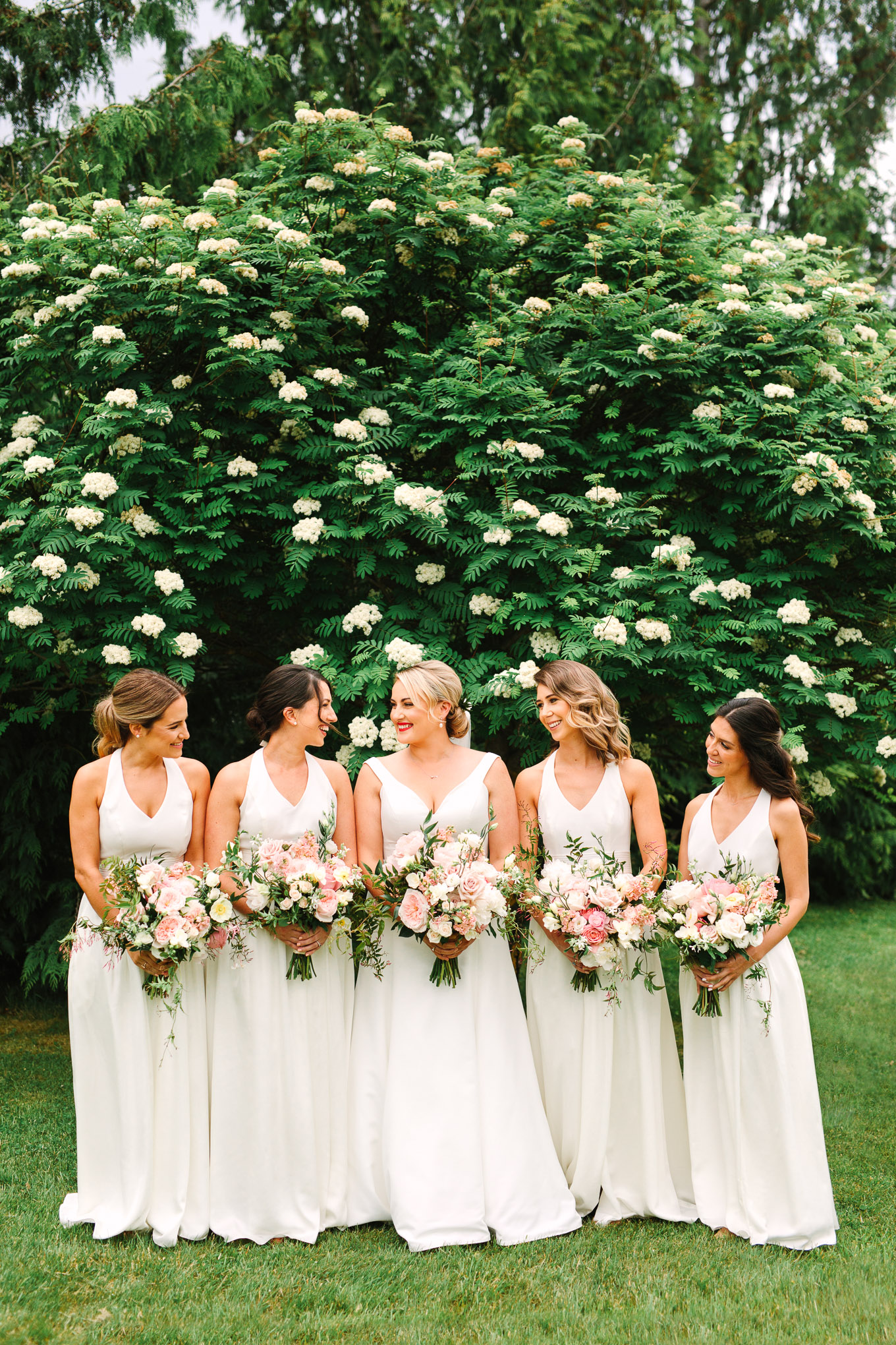 Bridesmaids in all white. Millbrook Resort Queenstown New Zealand wedding by Mary Costa Photography | www.marycostaweddings.com