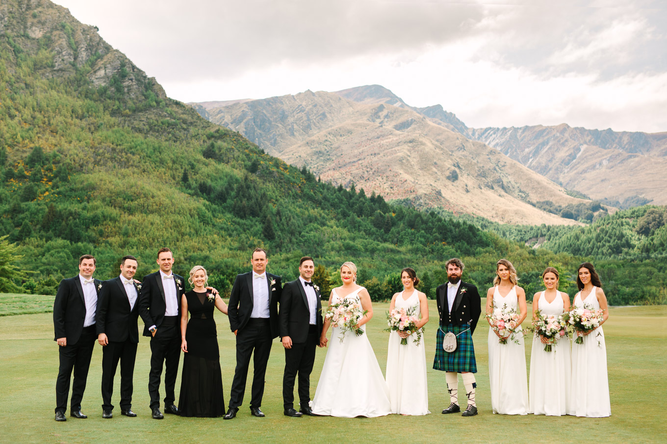 Wedding party with mountain backdrop. Millbrook Resort Queenstown New Zealand wedding by Mary Costa Photography | www.marycostaweddings.com