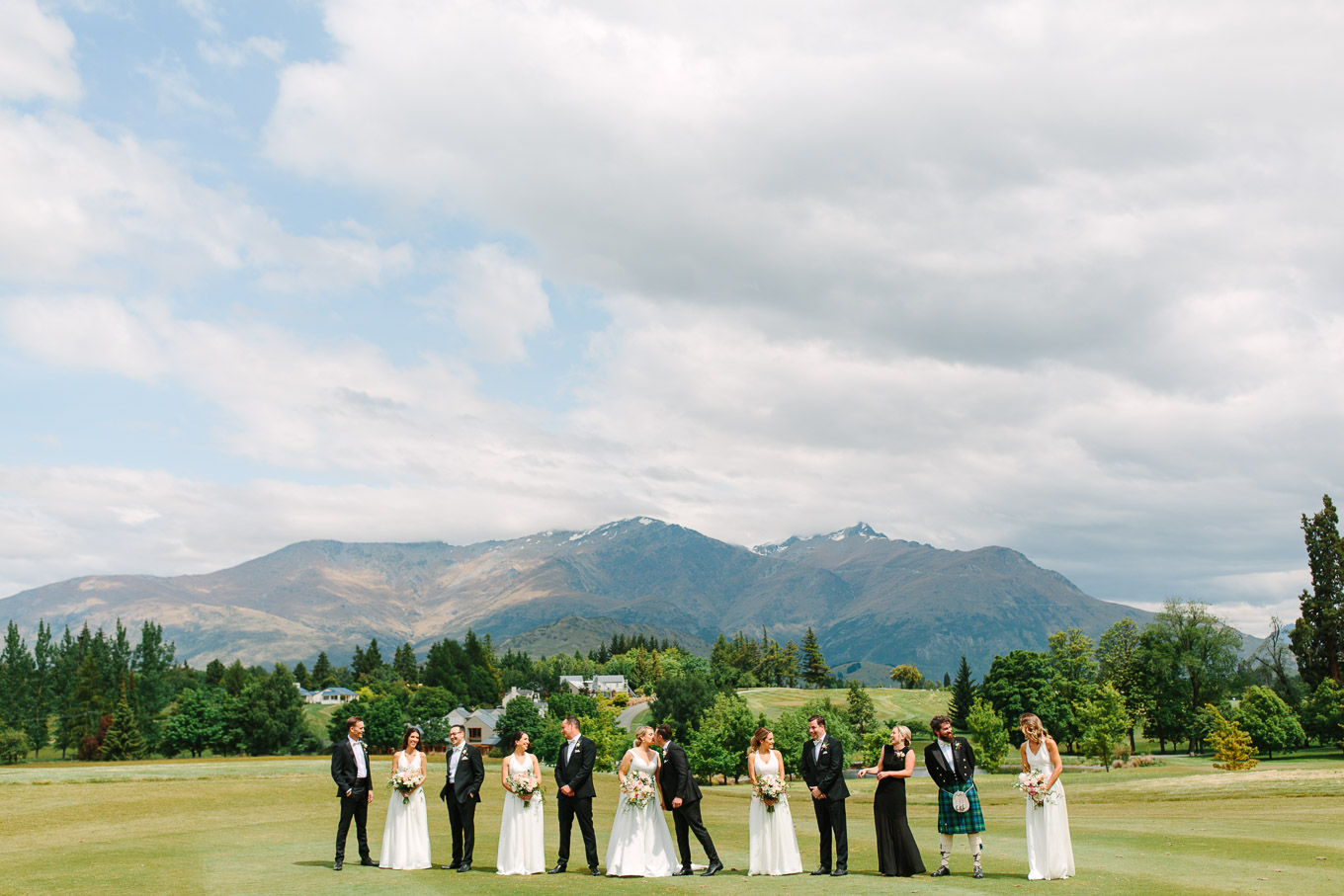 Wide shot of the wedding party among the mountains. Millbrook Resort Queenstown New Zealand wedding by Mary Costa Photography | www.marycostaweddings.com