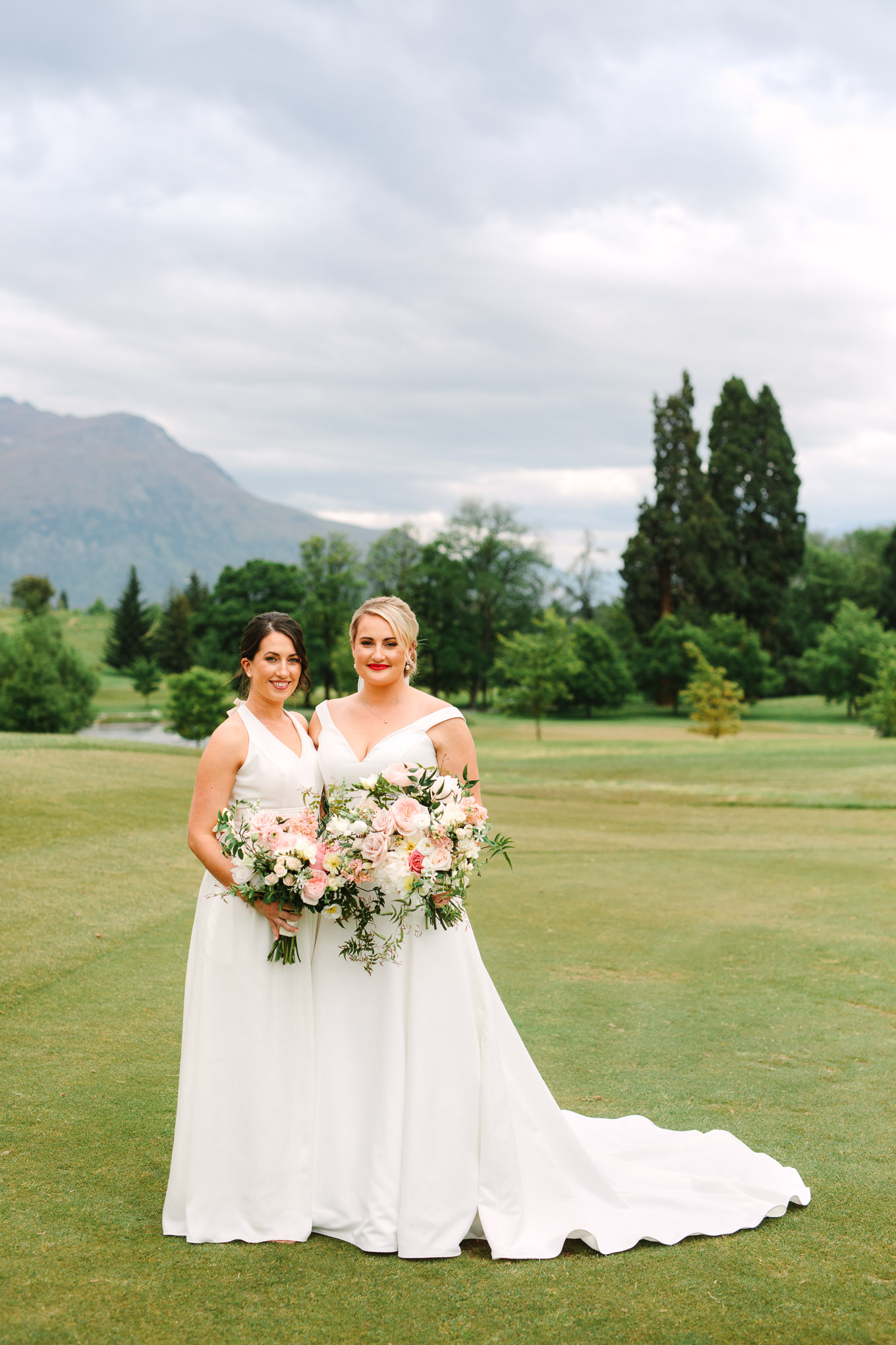 Bride and matron of honor, both in all white. Millbrook Resort Queenstown New Zealand wedding by Mary Costa Photography | www.marycostaweddings.com