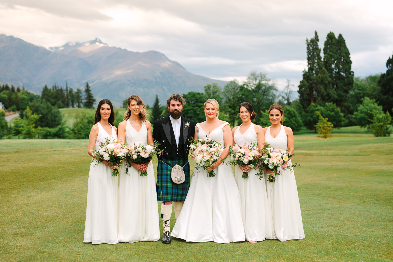 Bridal party with beautiful mountain backdrop. Millbrook Resort Queenstown New Zealand wedding by Mary Costa Photography | www.marycostaweddings.com