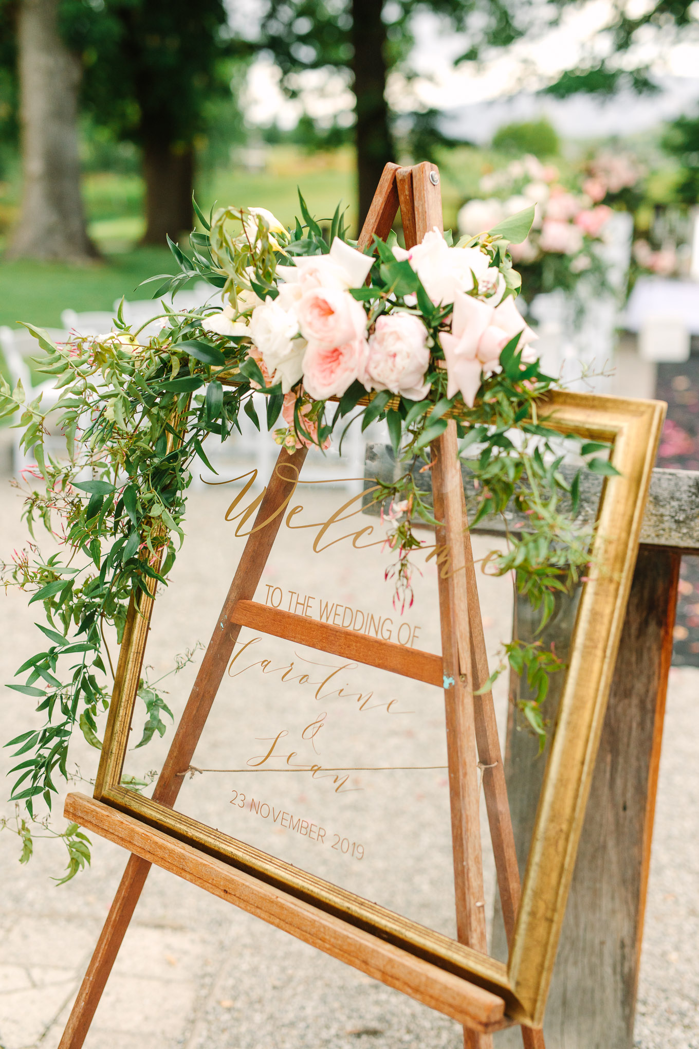 Calligraphy welcome frame with flowers at wedding ceremony. Millbrook Resort Queenstown New Zealand wedding by Mary Costa Photography | www.marycostaweddings.com