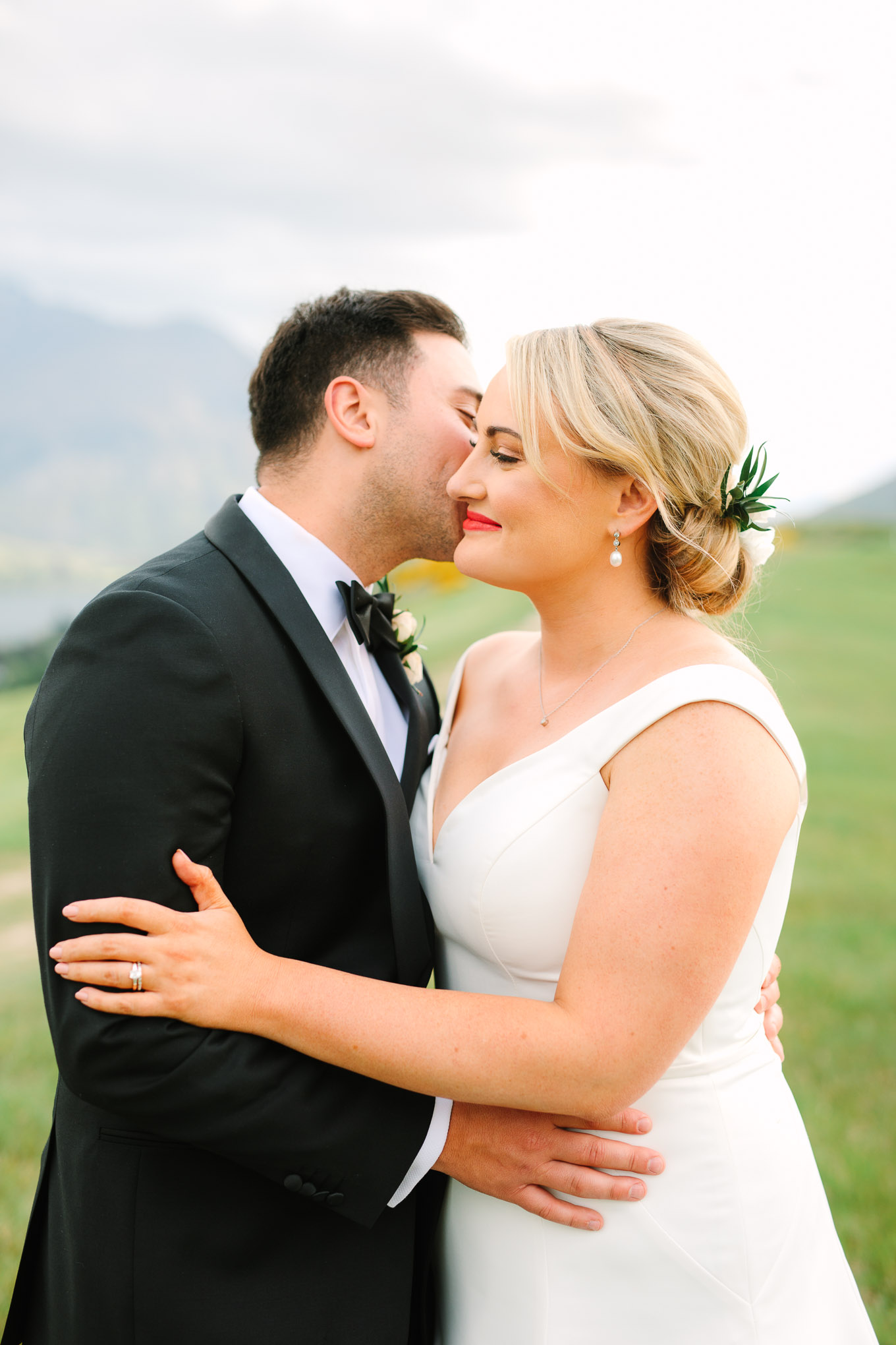 Groom and bride embracing. Millbrook Resort Queenstown New Zealand wedding by Mary Costa Photography | www.marycostaweddings.com