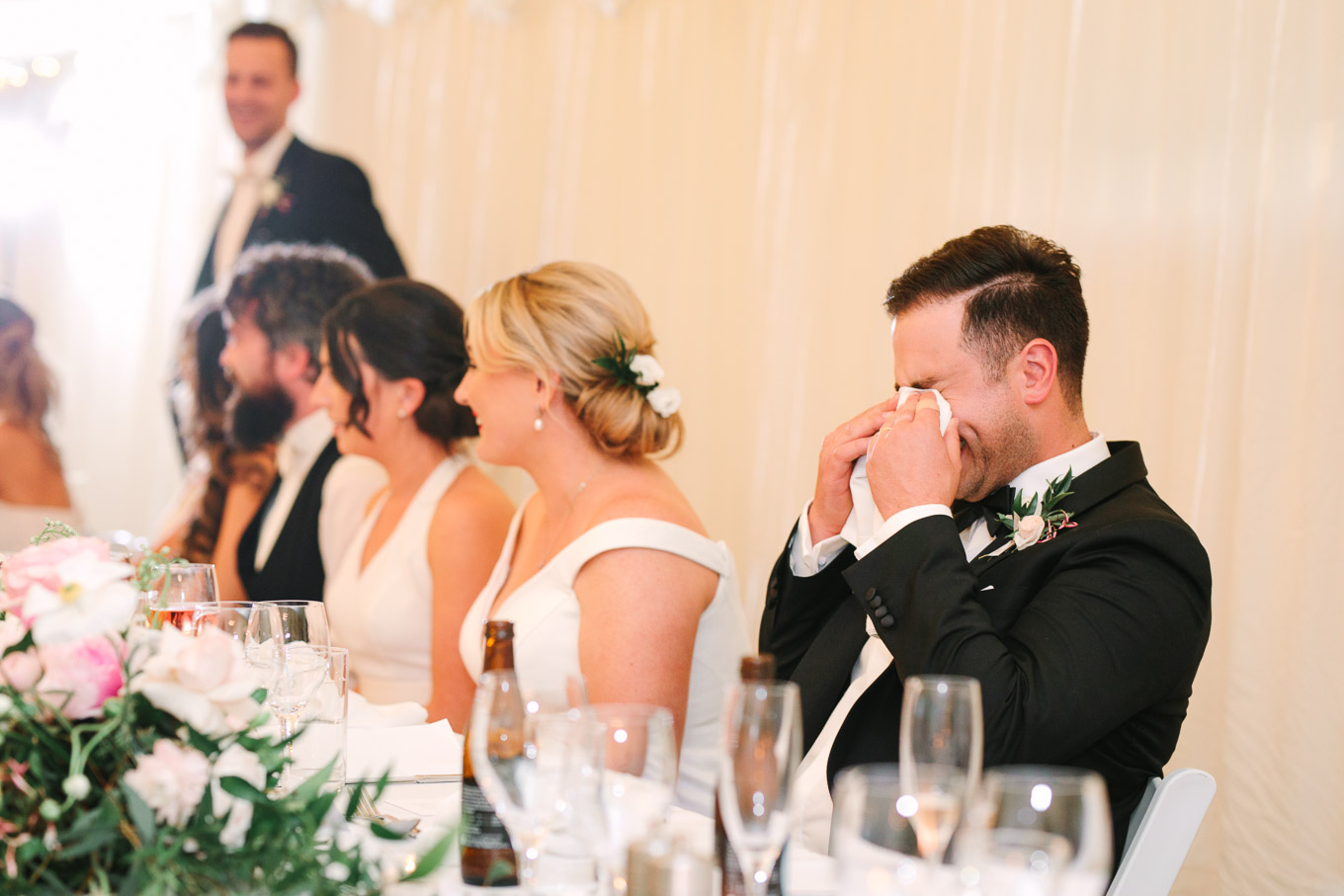 Groom laughing during speeches. Millbrook Resort Queenstown New Zealand wedding by Mary Costa Photography | www.marycostaweddings.com