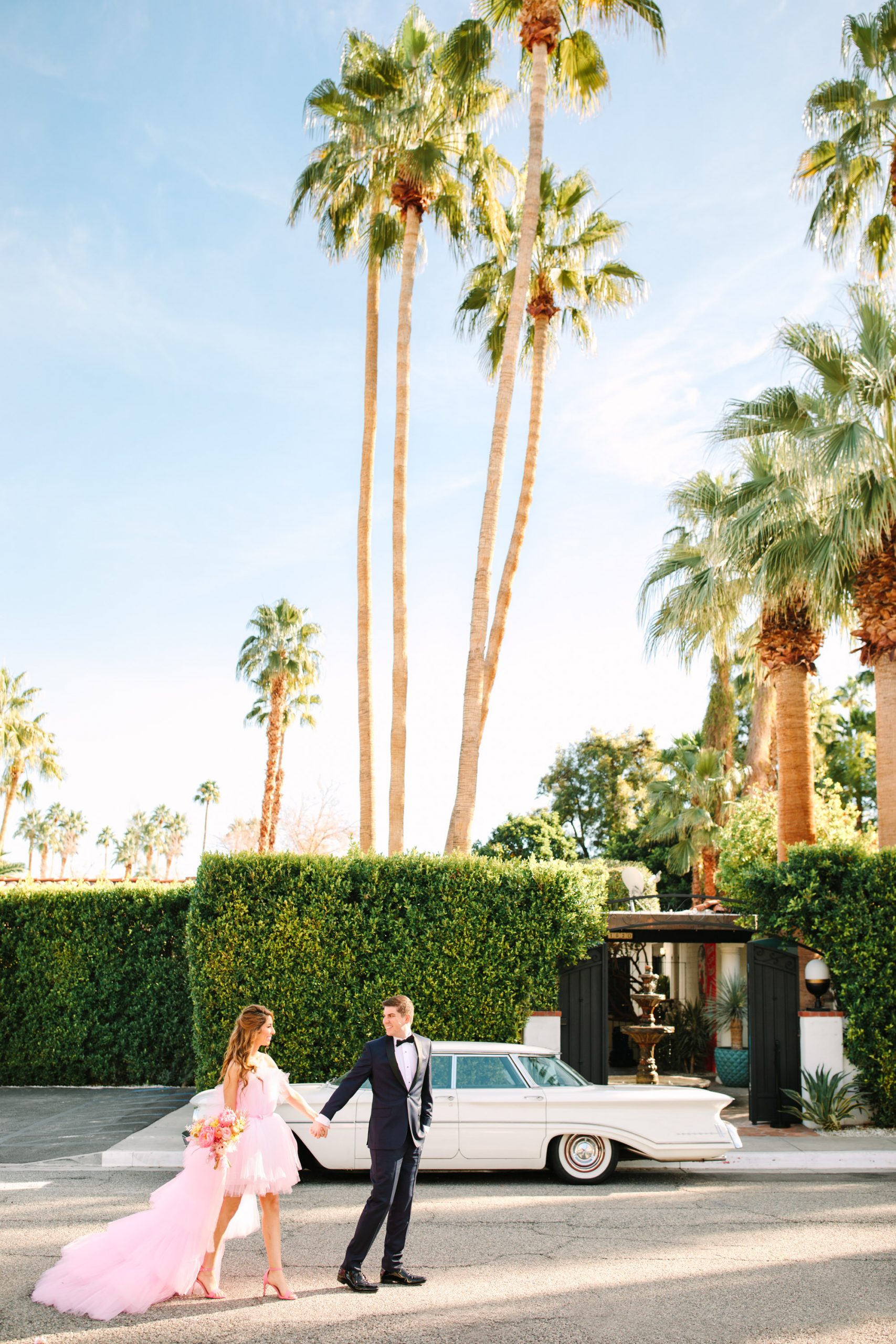 Pink wedding dress Palm Springs elopement featured on Green Wedding Shoes | Colorful mid-century modern wedding with Villa Royale Hotel backdrop | Vibrant and elevated wedding photos for fun-loving couples in Southern California #palmspringswedding #palmspringselopement #pinkwedding #greenweddingshoes Source: Mary Costa Photography | Los Angeles