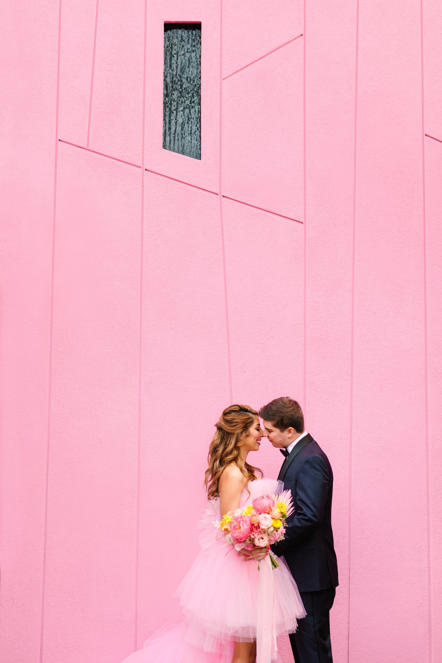 Pink wedding dress Palm Springs elopement featured on Green Wedding Shoes | Colorful mid-century modern wedding with Saguaro Hotel backdrop | Vibrant and elevated wedding photos for fun-loving couples in Southern California #palmspringswedding #palmspringselopement #pinkwedding #greenweddingshoes Source: Mary Costa Photography | Los Angeles
