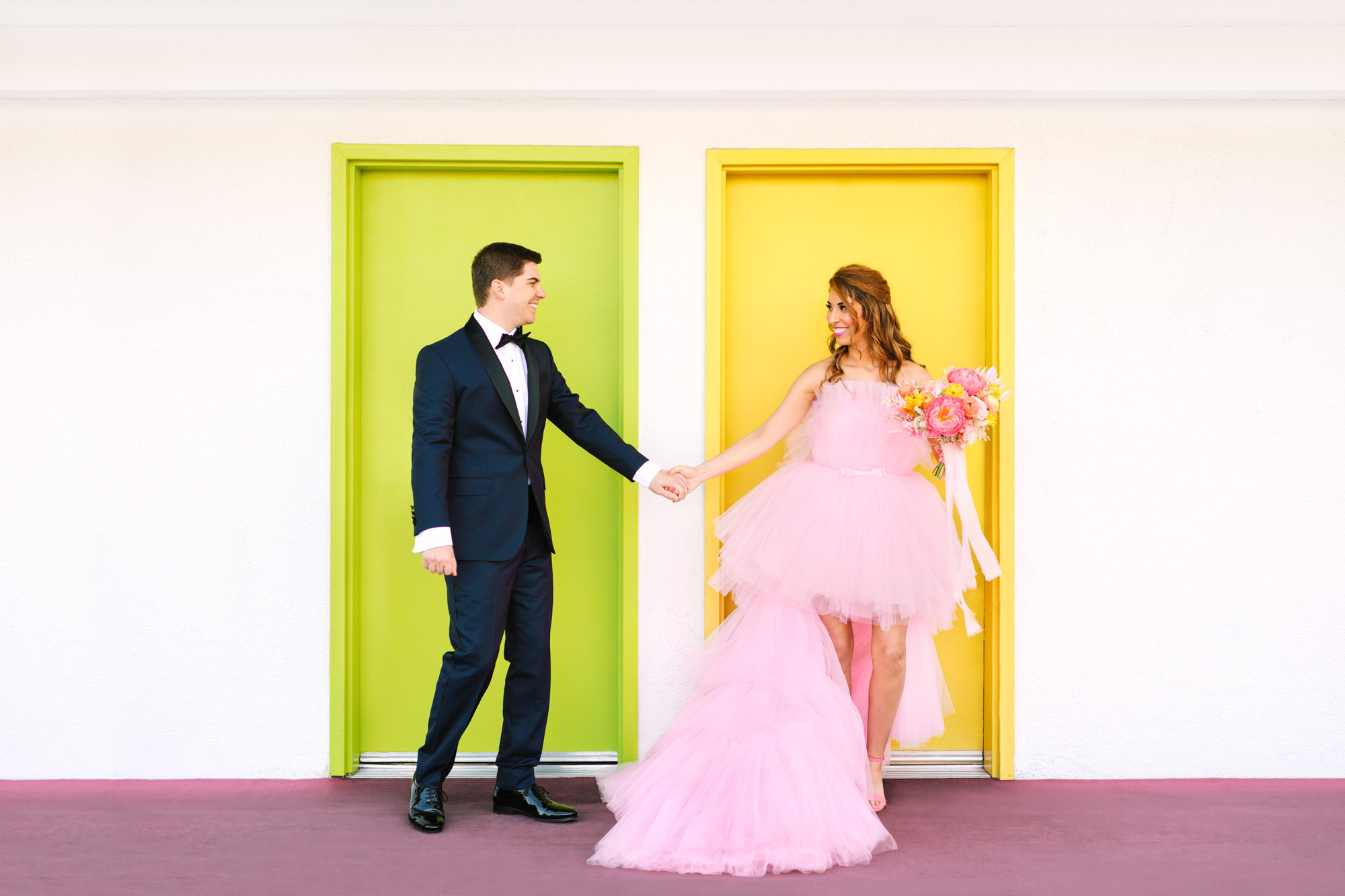 Pink wedding dress Palm Springs elopement featured on Green Wedding Shoes | Colorful mid-century modern wedding with Saguaro Hotel backdrop | Vibrant and elevated wedding photos for fun-loving couples in Southern California #palmspringswedding #palmspringselopement #pinkwedding #greenweddingshoes Source: Mary Costa Photography | Los Angeles