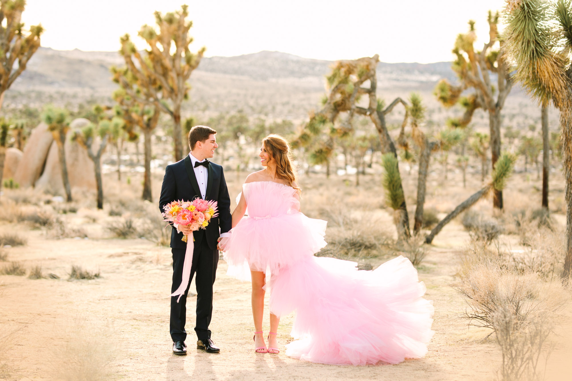 Pink wedding dress Joshua Tree elopement featured on Green Wedding Shoes | Colorful desert wedding inspiration for fun-loving couples in Southern California #joshuatreewedding #joshuatreeelopement #pinkwedding #greenweddingshoes Source: Mary Costa Photography | Los Angeles