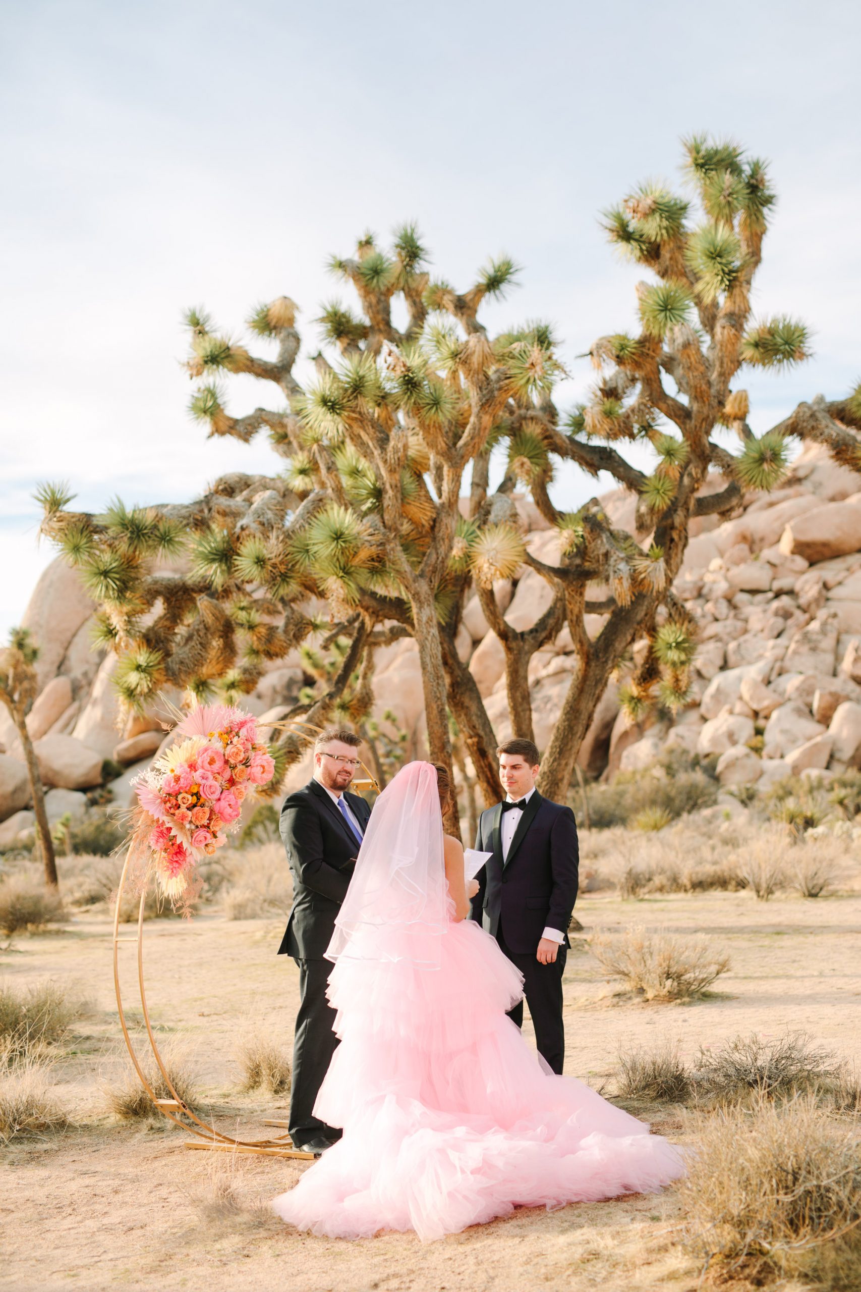 Pink elopement ceremony | Pink wedding dress Joshua Tree elopement featured on Green Wedding Shoes | Colorful desert wedding inspiration for fun-loving couples in Southern California #joshuatreewedding #joshuatreeelopement #pinkwedding #greenweddingshoes Source: Mary Costa Photography | Los Angeles