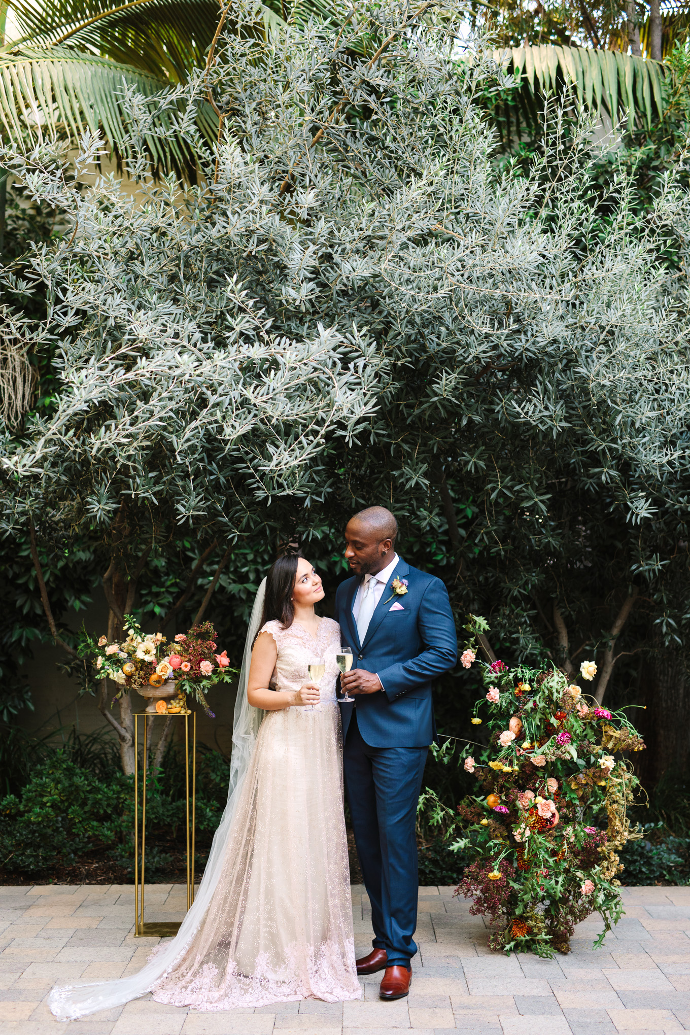 Bride and groom toasting in Vibiana Courtyard | Best Southern California Garden Wedding Venues | Colorful and elevated wedding photography for fun-loving couples | #gardenvenue #weddingvenue #socalweddingvenue #bouquetideas #uniquebouquet   Source: Mary Costa Photography | Los Angeles 