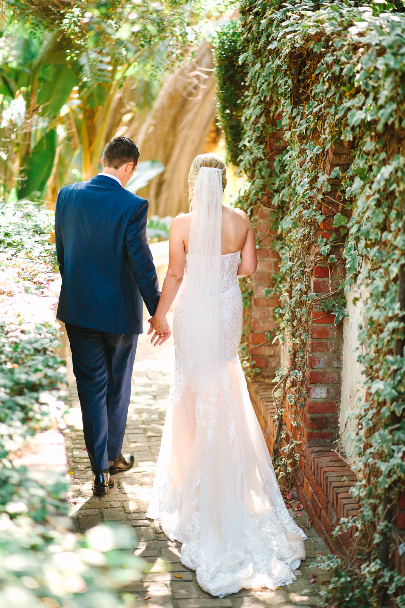 Bride and groom walking in secret garden at Houdini Estate wedding | Best Southern California Garden Wedding Venues | Colorful and elevated wedding photography for fun-loving couples | #gardenvenue #weddingvenue #socalweddingvenue #bouquetideas #uniquebouquet   Source: Mary Costa Photography | Los Angeles 
