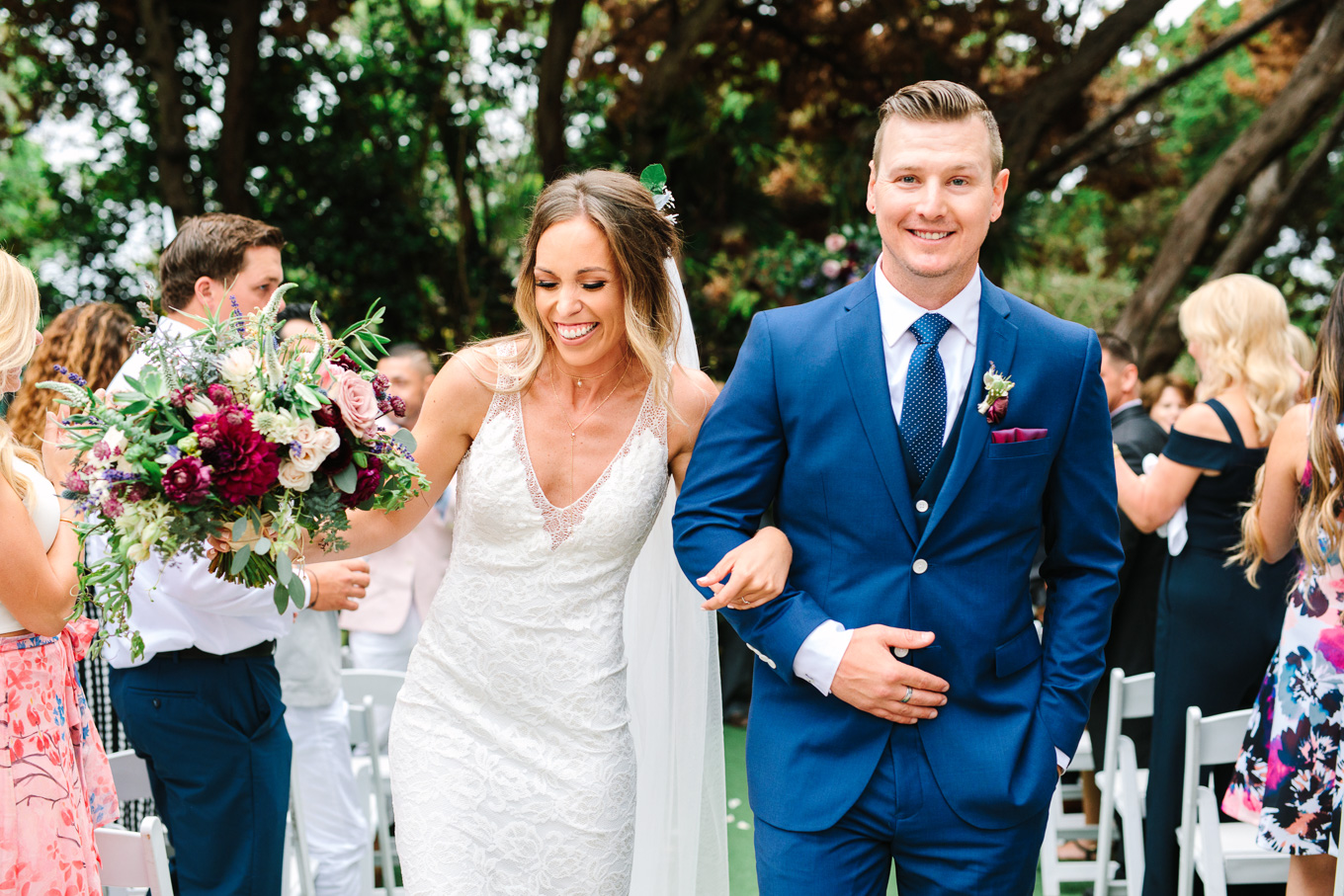 Bride and groom leaving ceremony at San Diego Botanic Garden wedding | Best Southern California Garden Wedding Venues | Colorful and elevated wedding photography for fun-loving couples | #gardenvenue #weddingvenue #socalweddingvenue #bouquetideas #uniquebouquet   Source: Mary Costa Photography | Los Angeles 