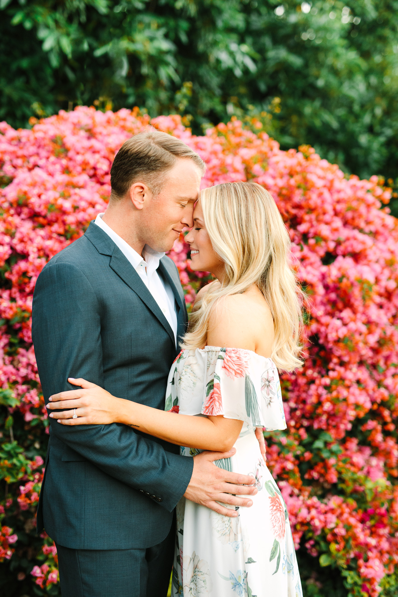 Couple embracing in front of flowers at Quail Ranch Simi Valley | Best Southern California Garden Wedding Venues | Colorful and elevated wedding photography for fun-loving couples | #gardenvenue #weddingvenue #socalweddingvenue #bouquetideas #uniquebouquet   Source: Mary Costa Photography | Los Angeles 