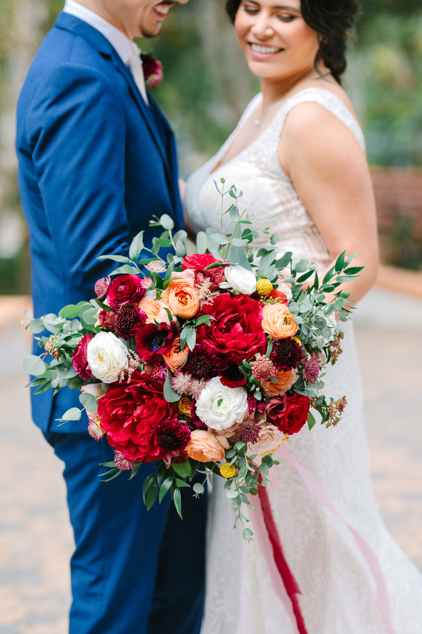 Lush red bridal bouquet at Rancho Las Lomas | Beautiful bridal bouquet inspiration and advice | Colorful and elevated wedding photography for fun-loving couples in Southern California | #weddingflowers #weddingbouquet #bridebouquet #bouquetideas #uniquebouquet   Source: Mary Costa Photography | Los Angeles