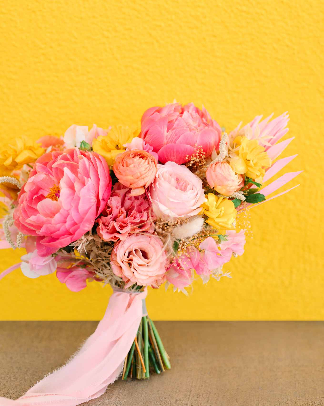 Colorful pink peony bouquet at Saguaro Palm Springs | Beautiful bridal bouquet inspiration and advice | Colorful and elevated wedding photography for fun-loving couples in Southern California | #weddingflowers #weddingbouquet #bridebouquet #bouquetideas #uniquebouquet   Source: Mary Costa Photography | Los Angeles