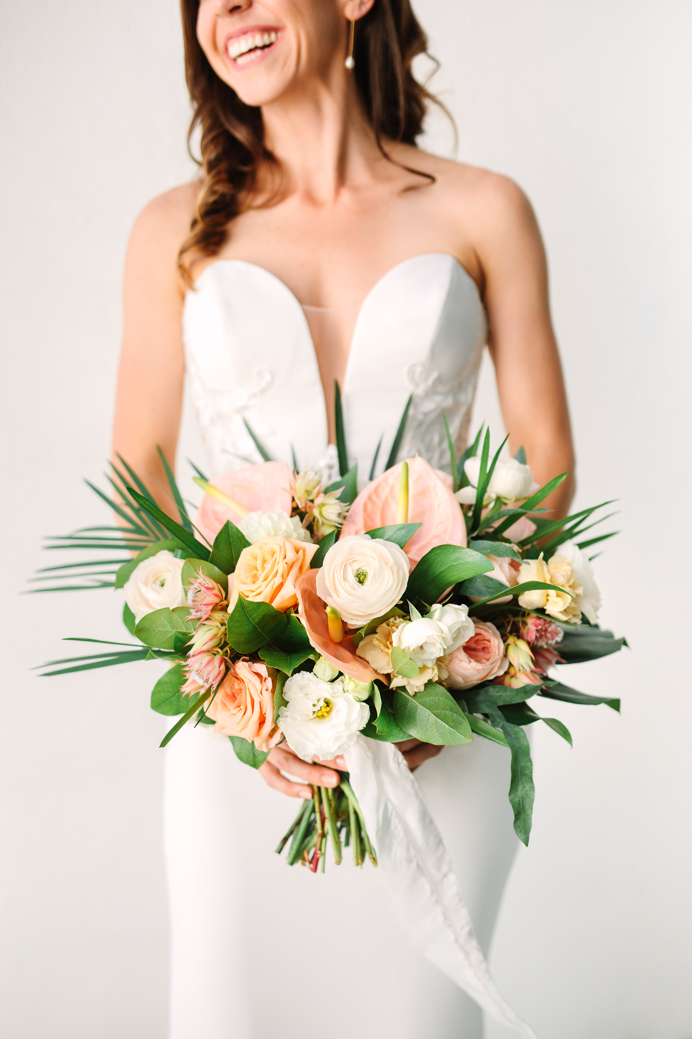 Bride with neutral and peach tropical bouquet | Beautiful bridal bouquet inspiration and advice | Colorful and elevated wedding photography for fun-loving couples in Southern California | #weddingflowers #weddingbouquet #bridebouquet #bouquetideas #uniquebouquet   Source: Mary Costa Photography | Los Angeles