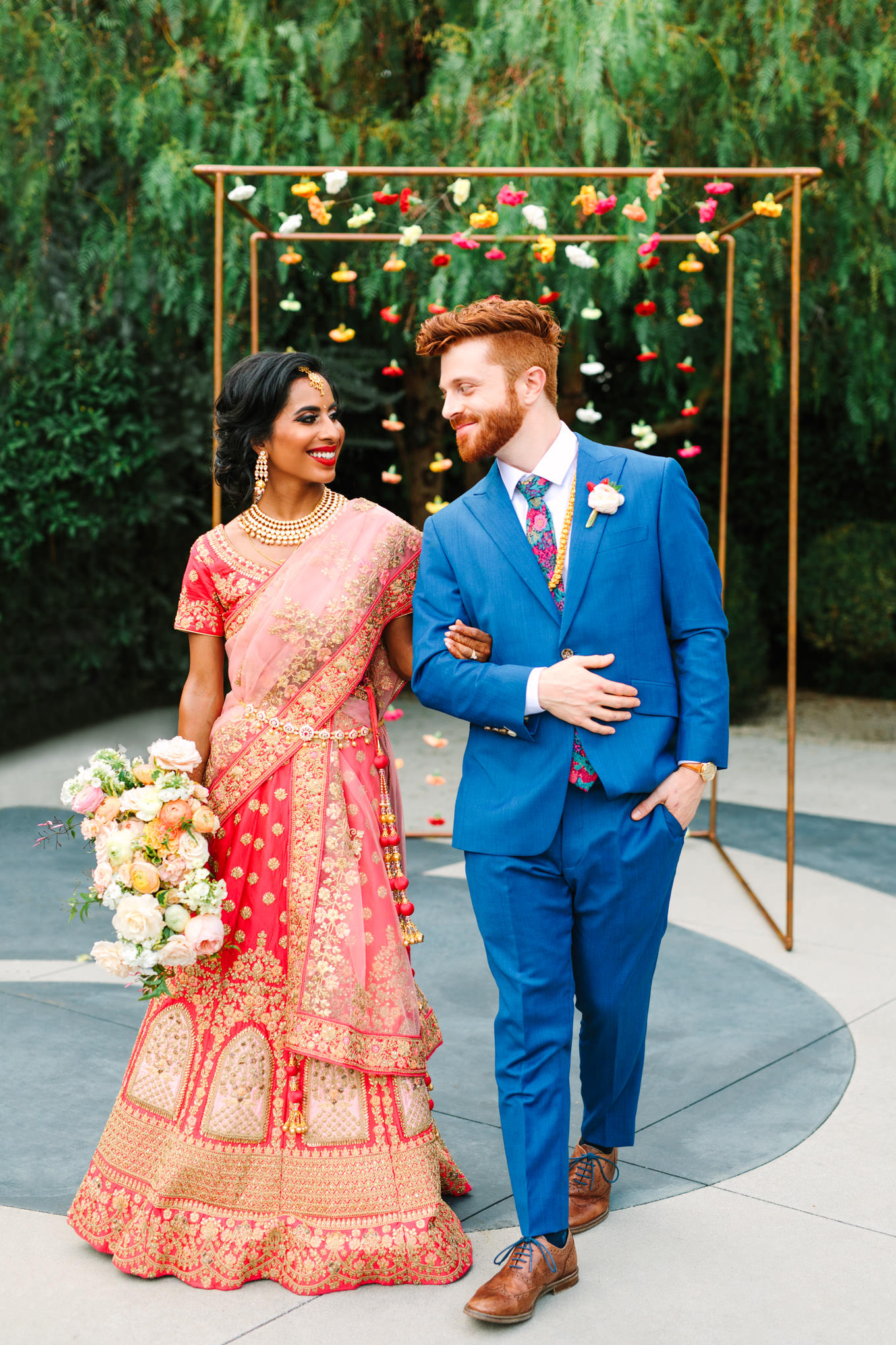 Bride in red saree and groom in bright blue suit. Two Disney artists create a unique and colorful Indian Fusion wedding at The Fig House Los Angeles, featured on Green Wedding Shoes. | Colorful and elevated wedding inspiration for fun-loving couples in Southern California | #indianwedding #indianfusionwedding #thefighouse #losangeleswedding   Source: Mary Costa Photography | Los Angeles